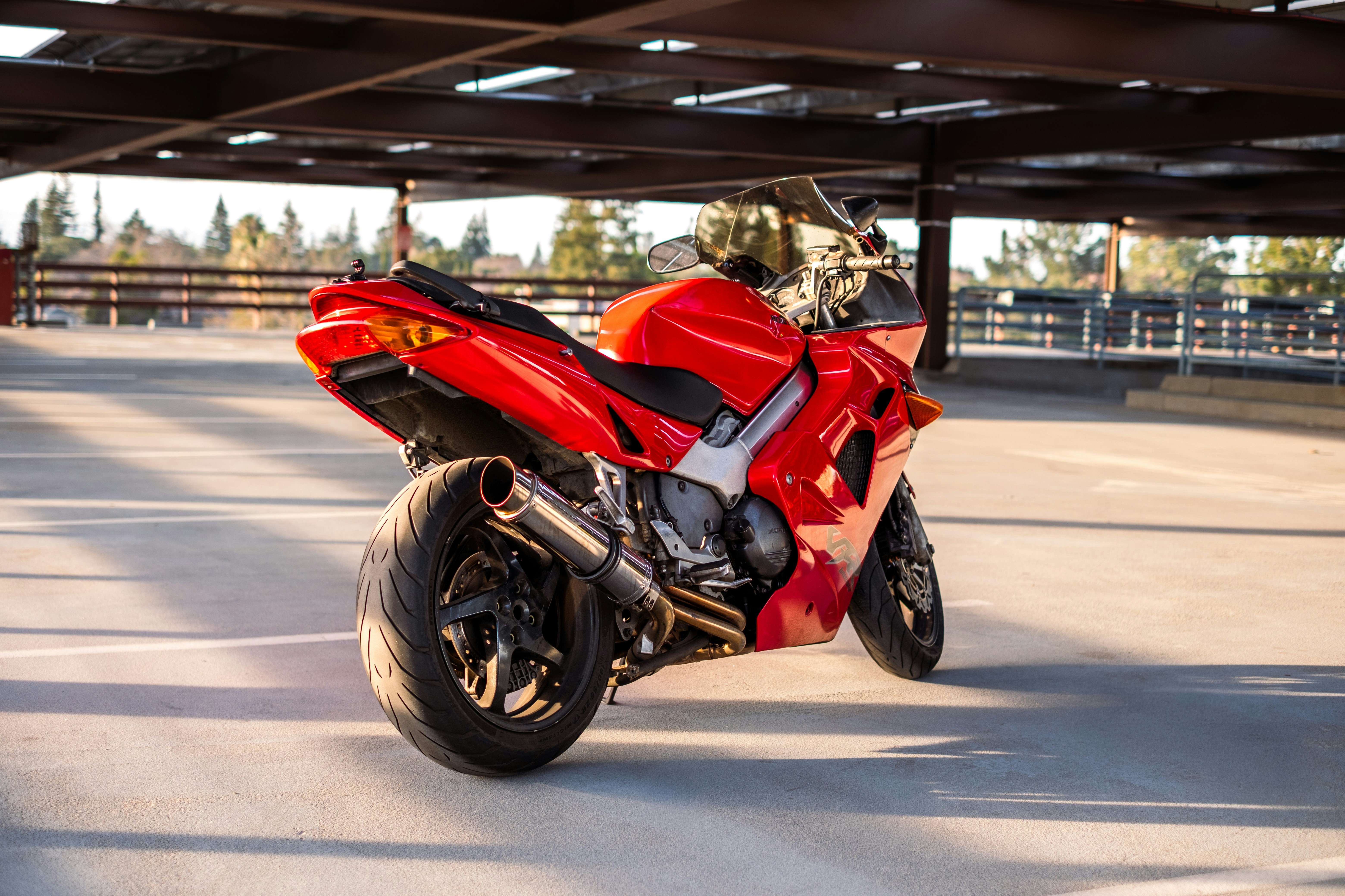 Red sport motorcycle in parking garage - Free Photo on Unsplash