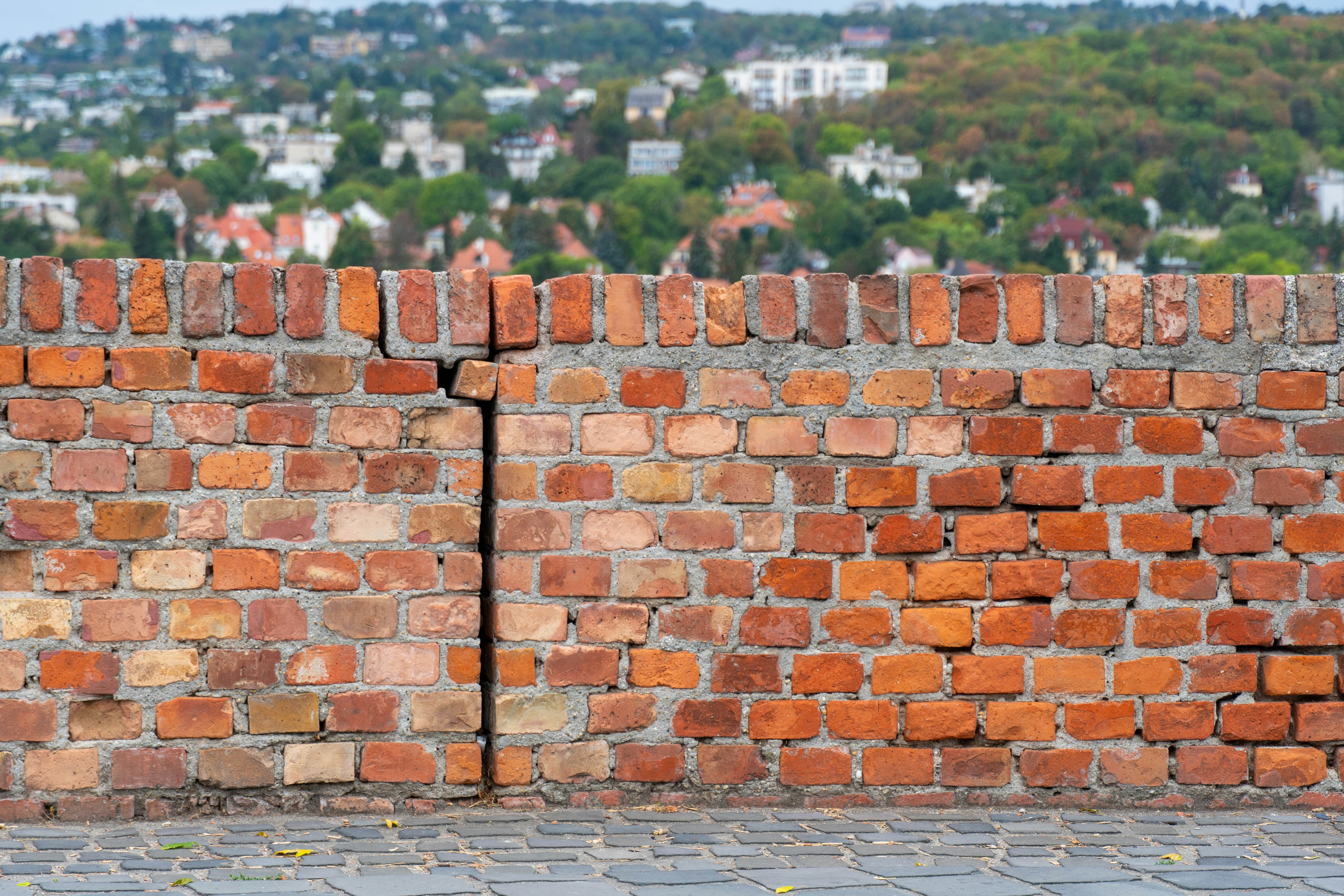 Weathered brick wall on cobblestone path - Free Photo on Unsplash