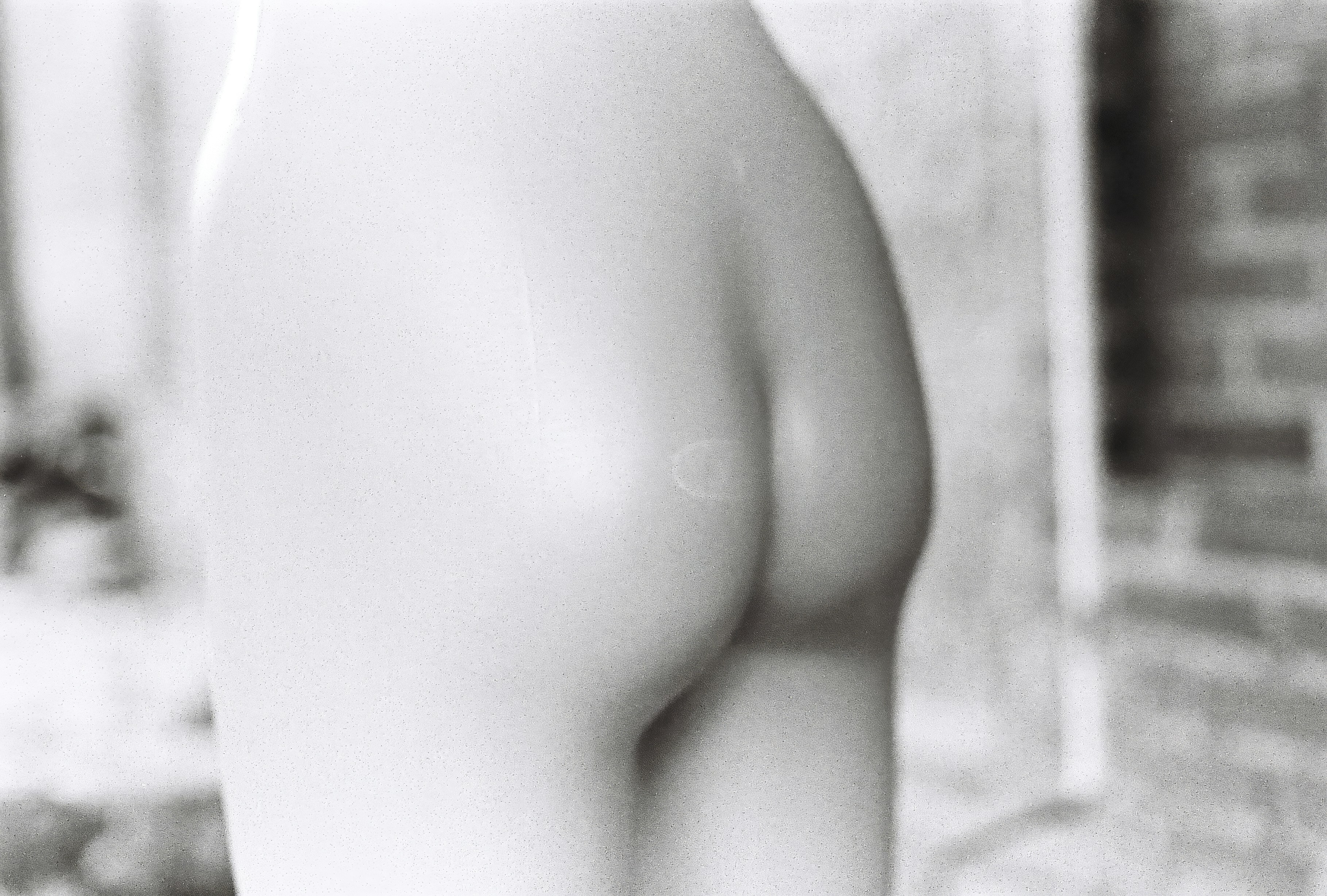 A black and white close-up of a smooth plastic mannequin torso