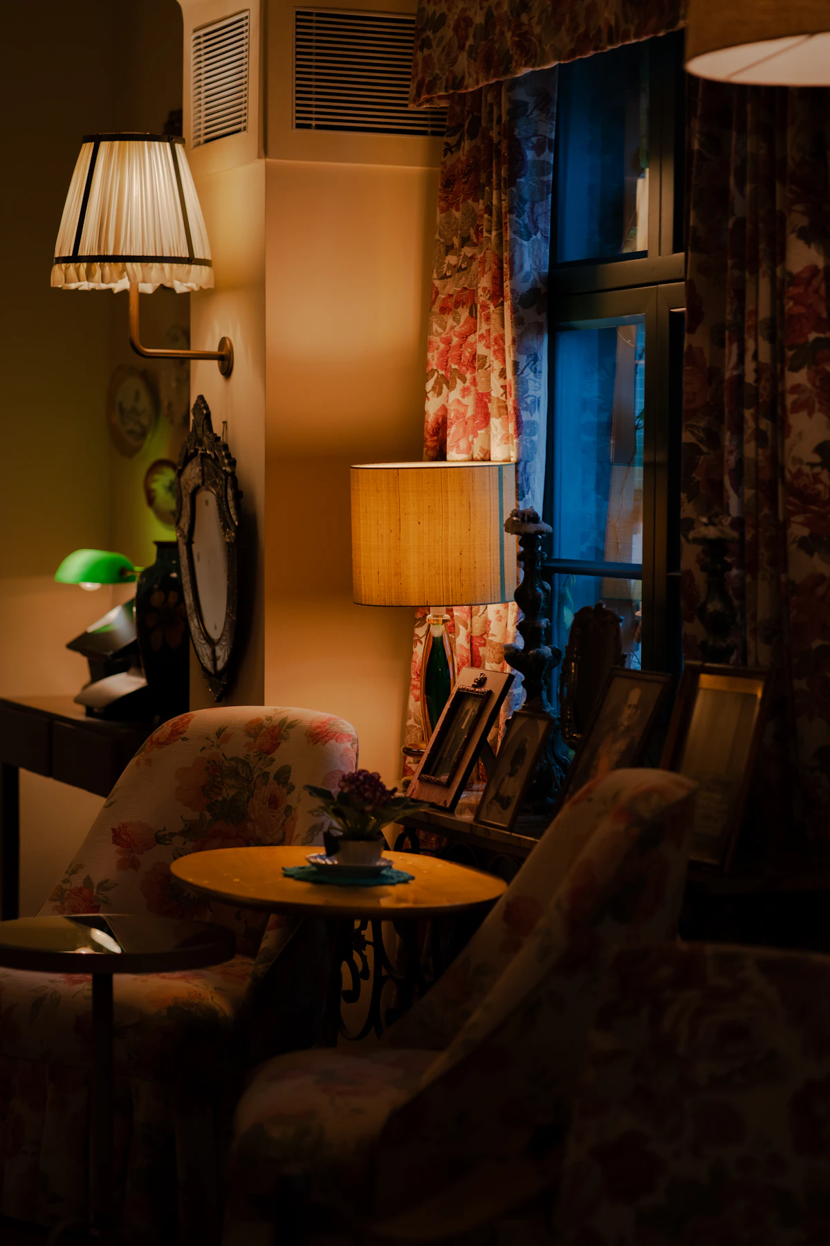 Cozy small lounge with layered warm lamps in the evening