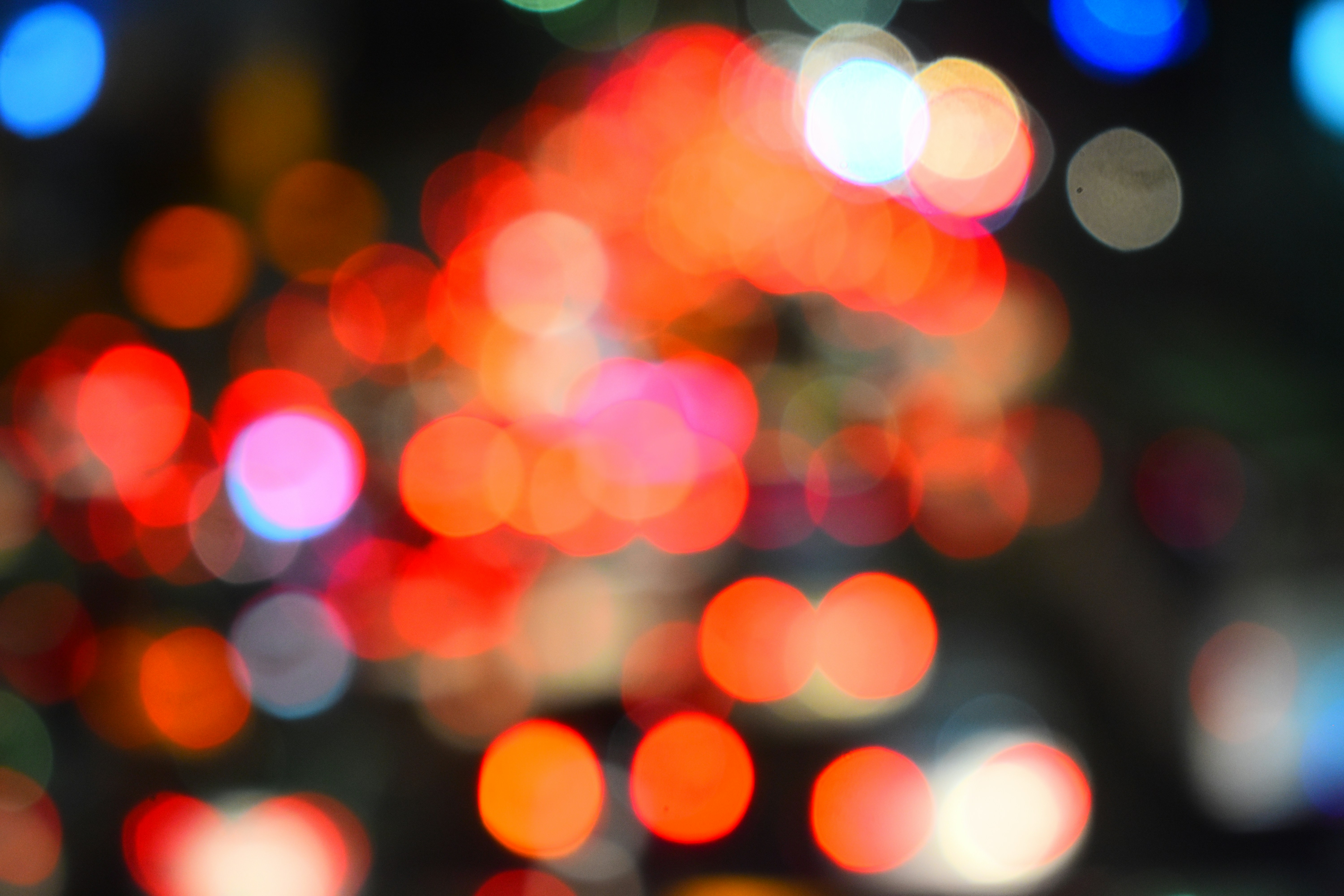 Blurred red and orange circular lights against a dark background