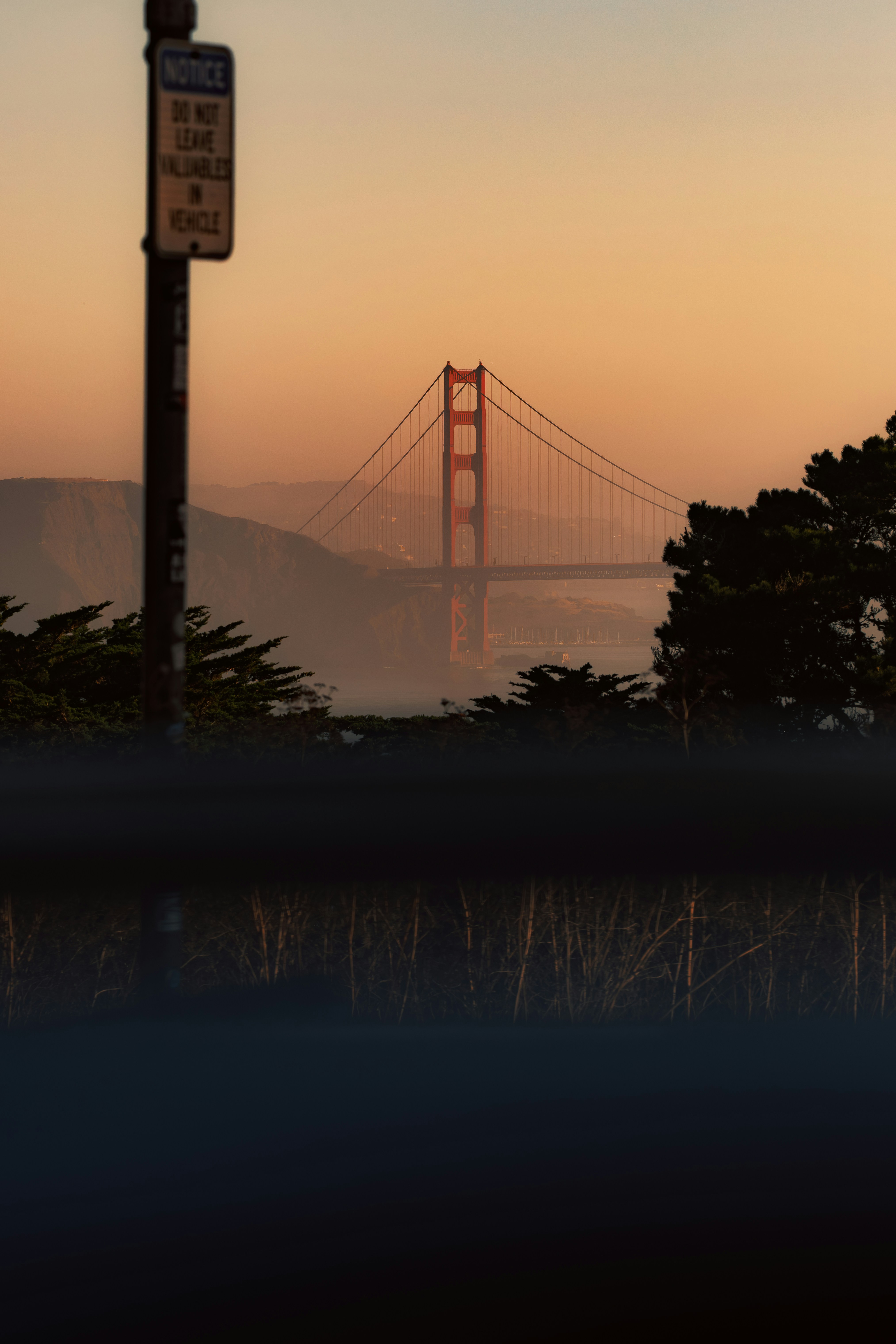 The Golden Gate Bridge in San Francisco under a warm orange sky