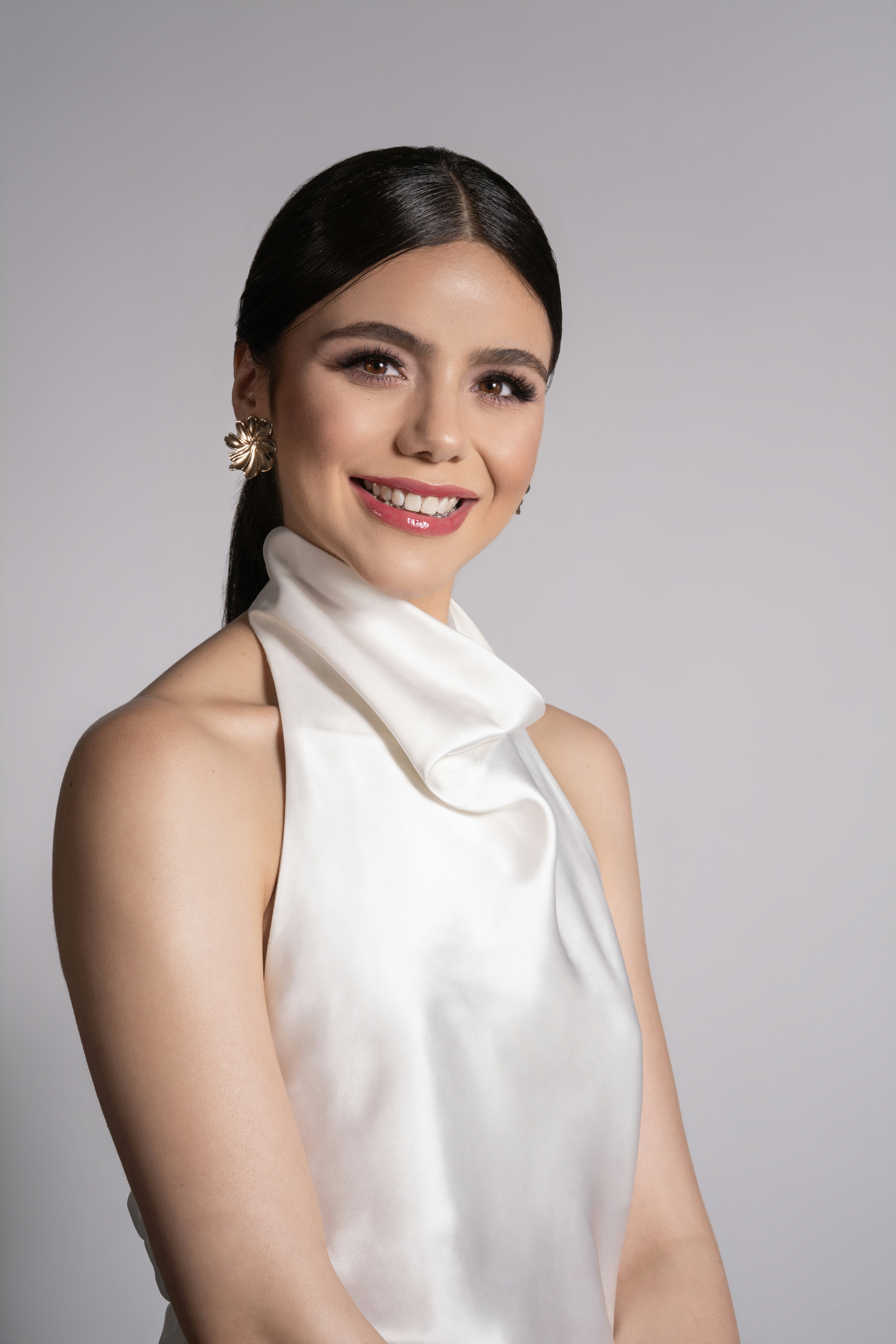 Mujer sonriente y segura con blusa blanca