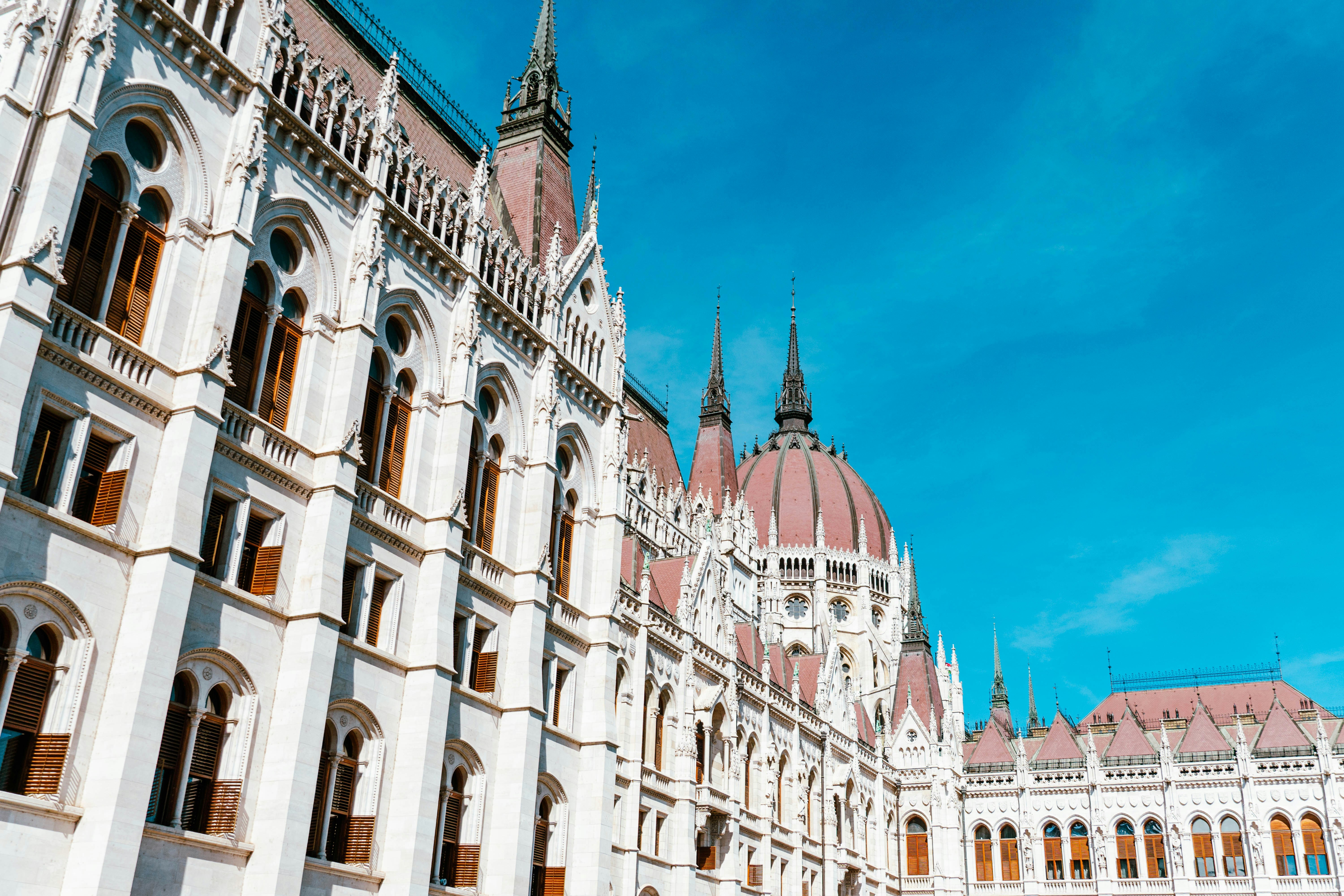 The Hungarian Parliament Building with its ornate white facade and red dome in Budapest