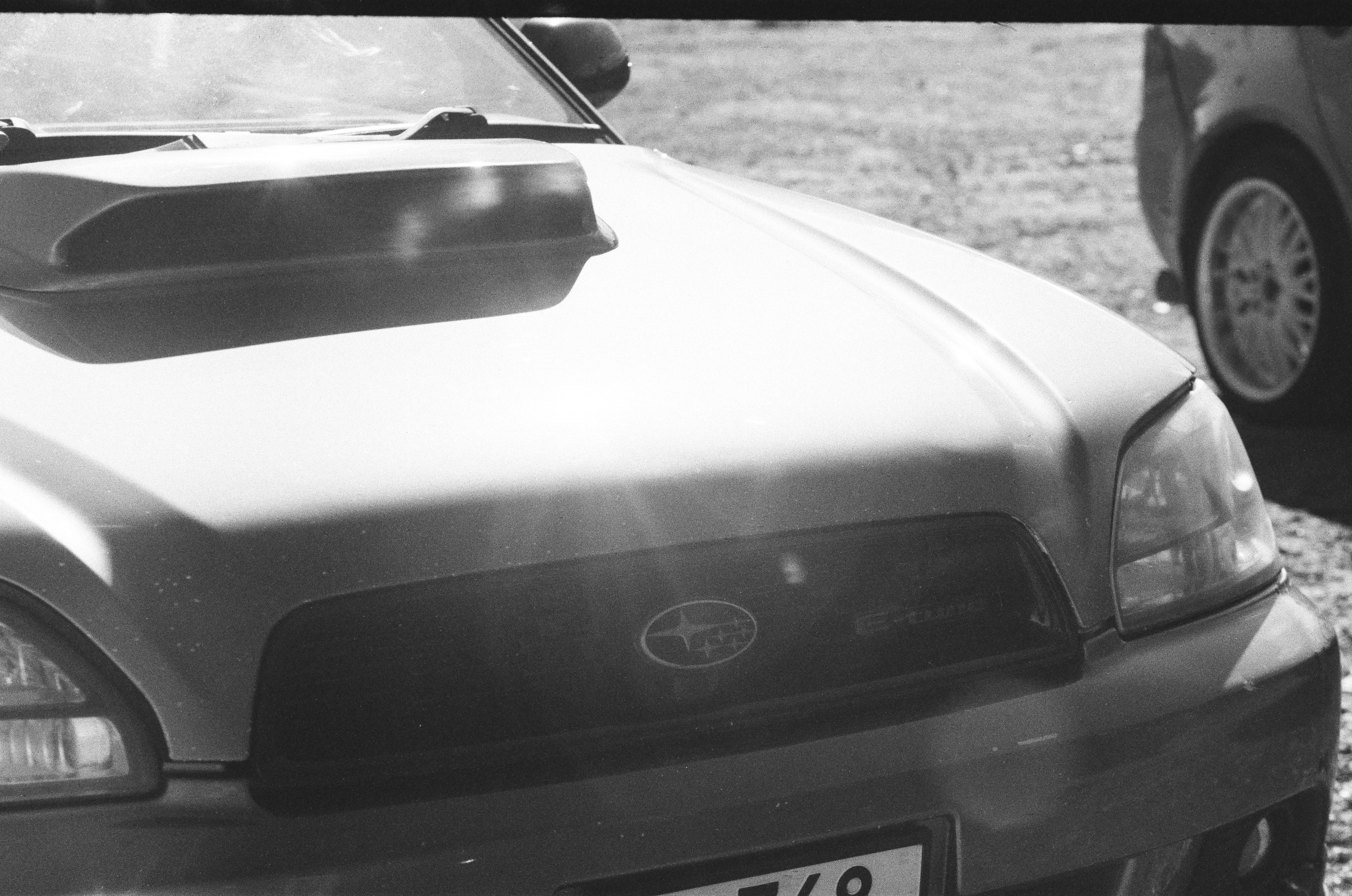 The front hood and grille of a Subaru car with a prominent air scoop