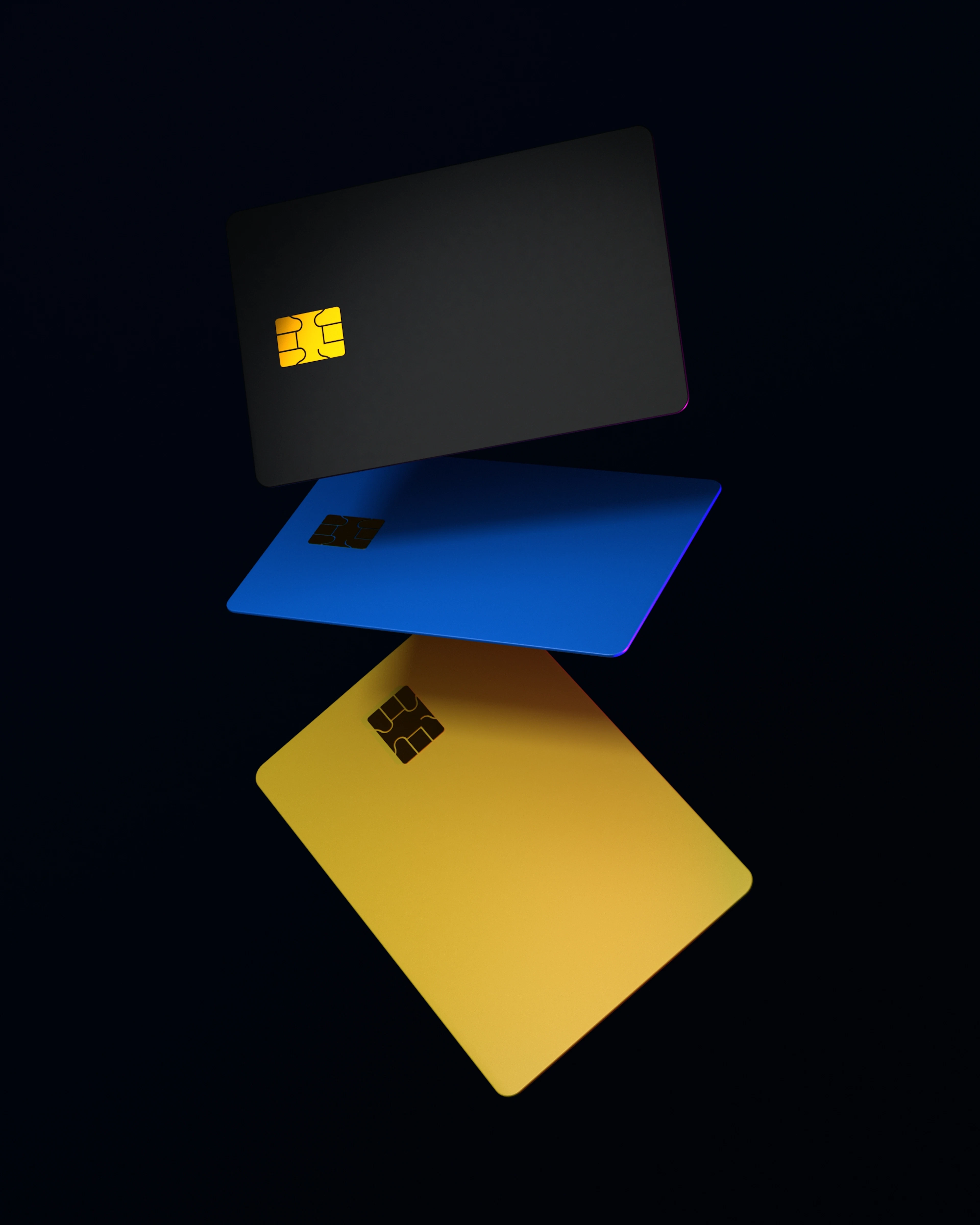 Three blank credit cards — black, blue, and yellow — floating against a dark background