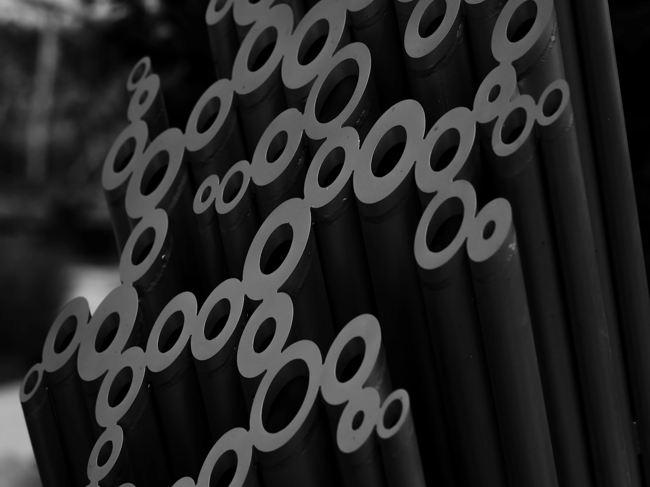 Cluster of dark hollow metal pipes with circular openings