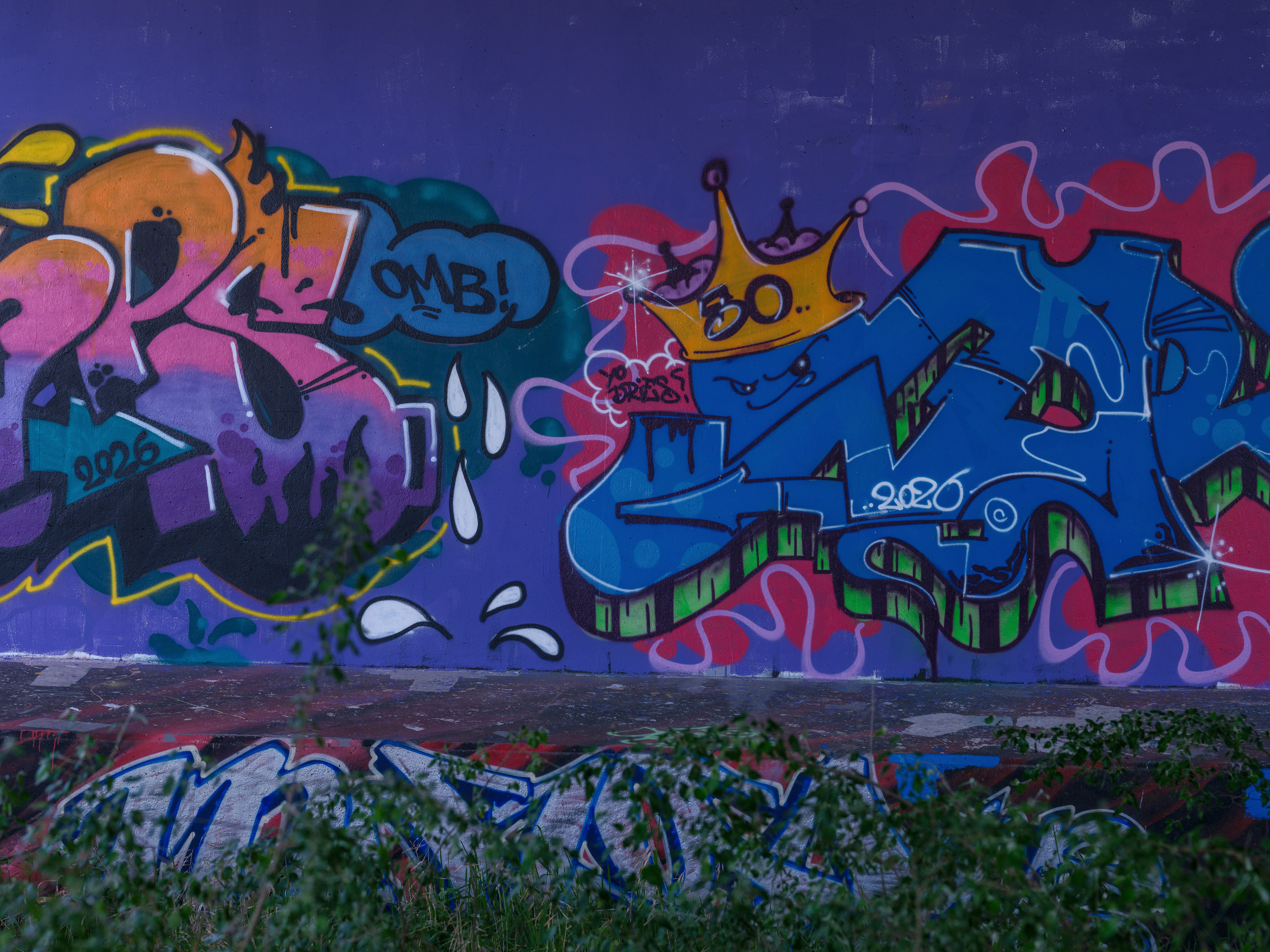 Colorful graffiti art on a purple wall under the Schellingwouderbrug in Amsterdam