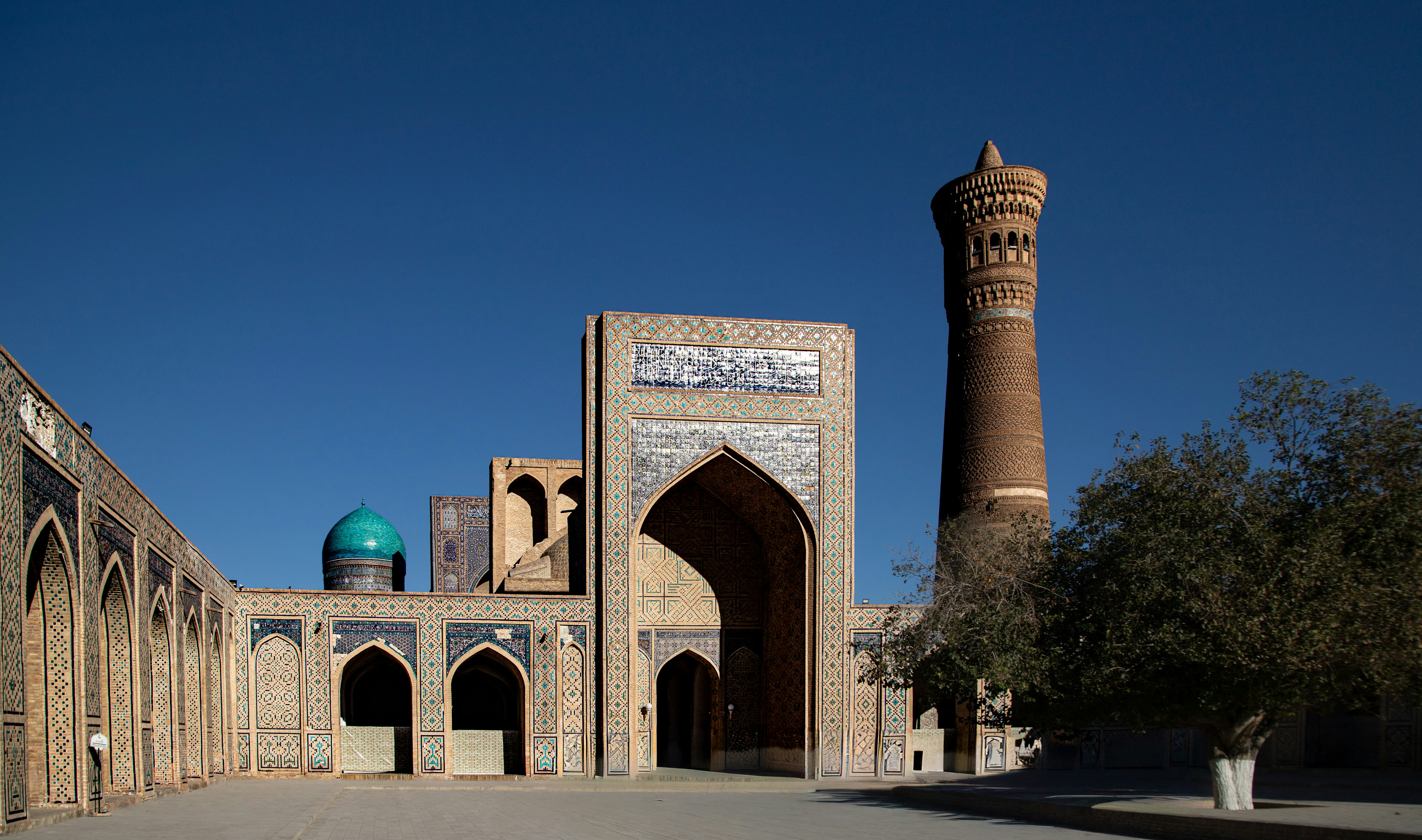 The Po-i-Kalyan complex with its tall brick minaret and blue dome in Bukhara