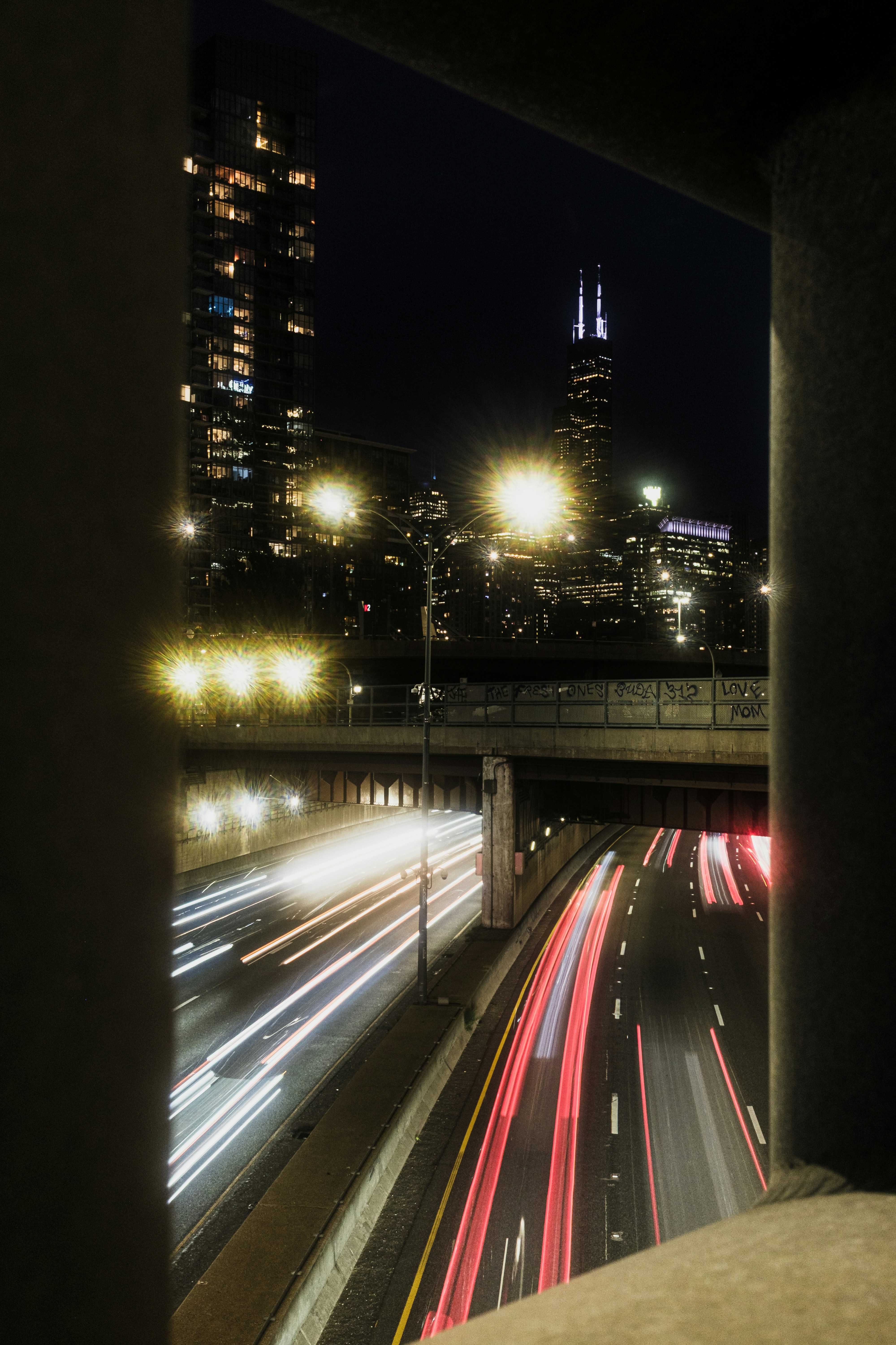 Long exposure light trails on a highway at night with the Chicago skyline
