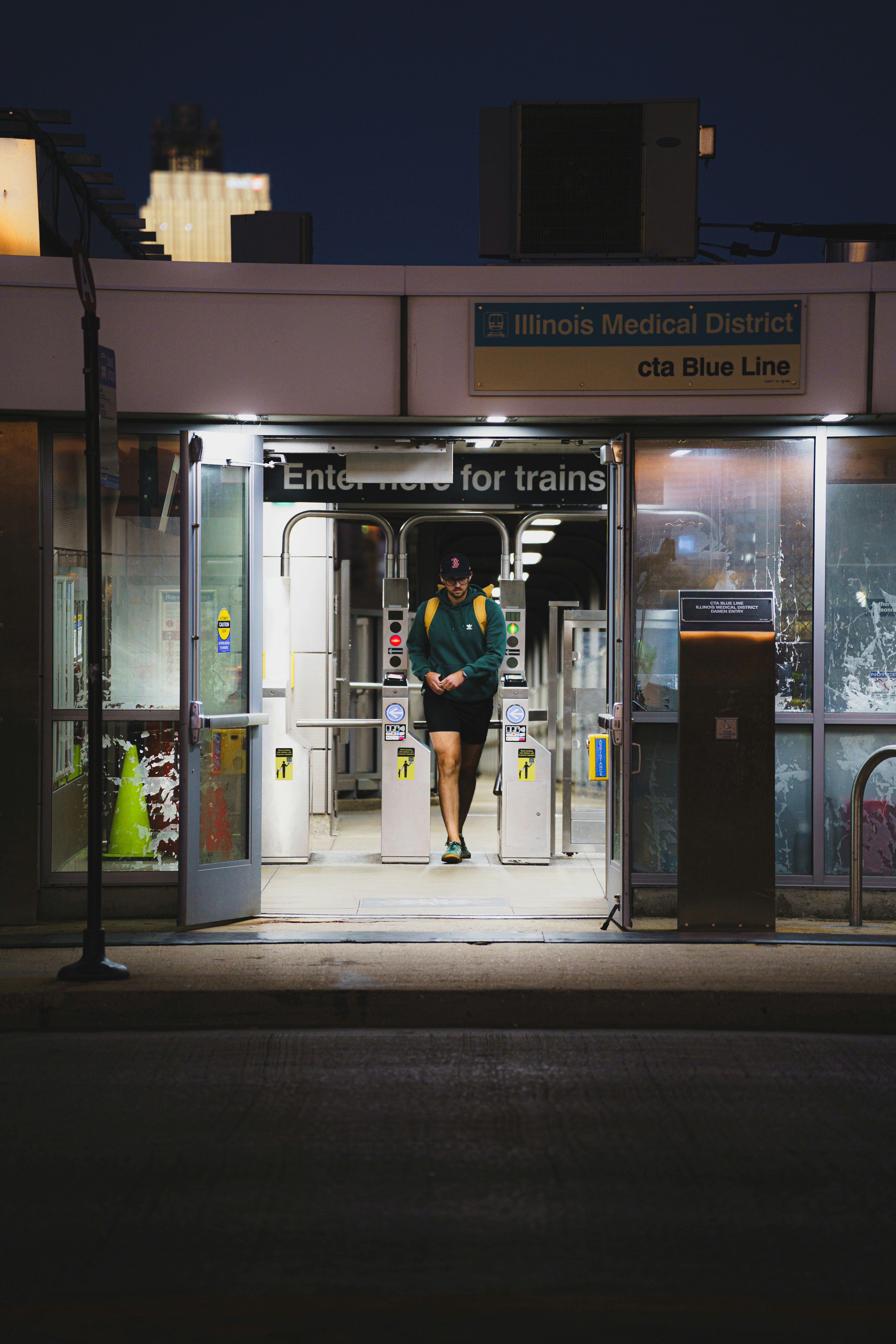 A person walking through turnstiles at the Illinois Medical District cta Blue Line station