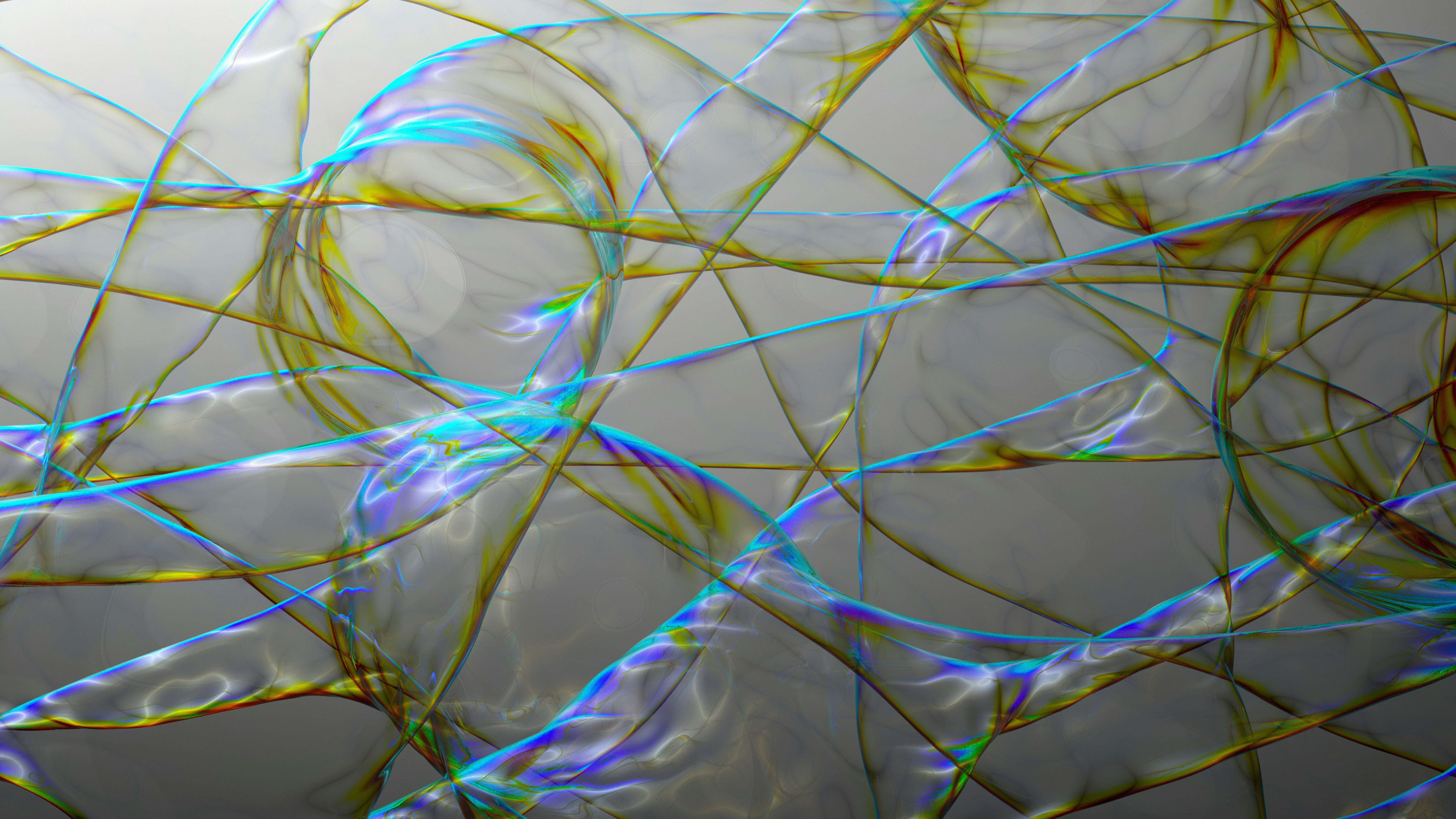 Iridescent soap film ribbons with blue and gold highlights on a grey background
