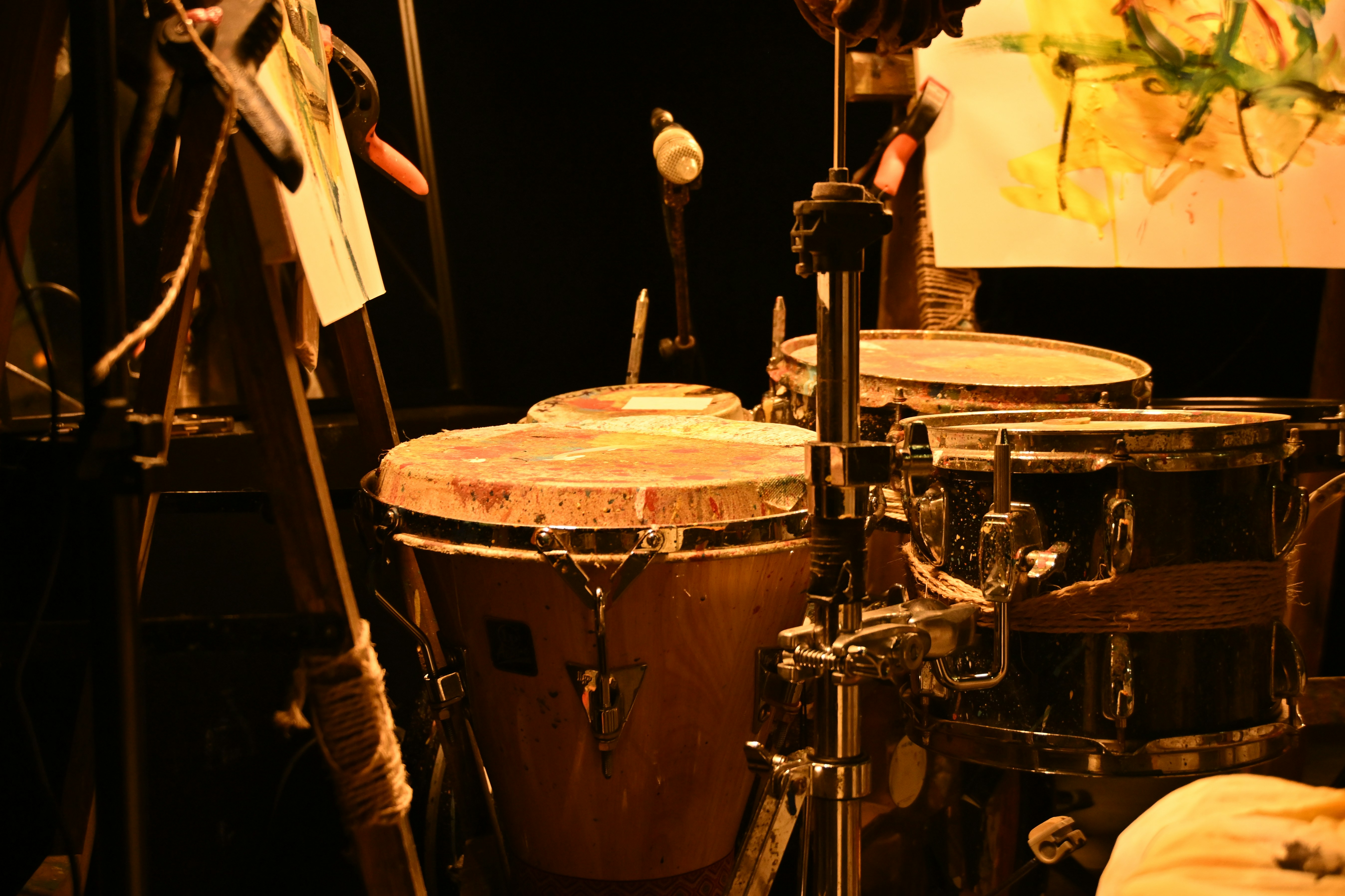 Conga drums set up on stage under warm light