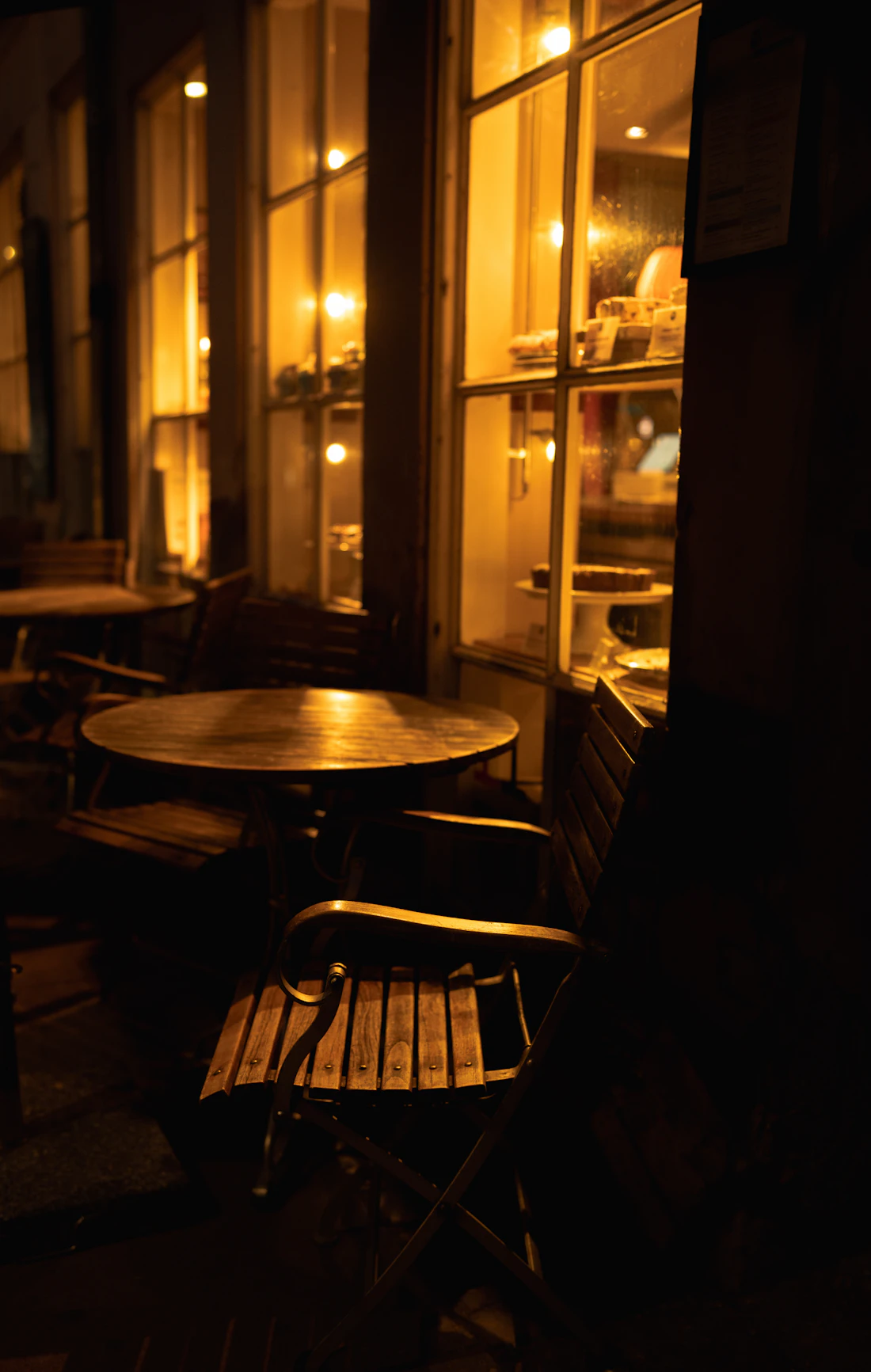 Café tables lit warmly at night