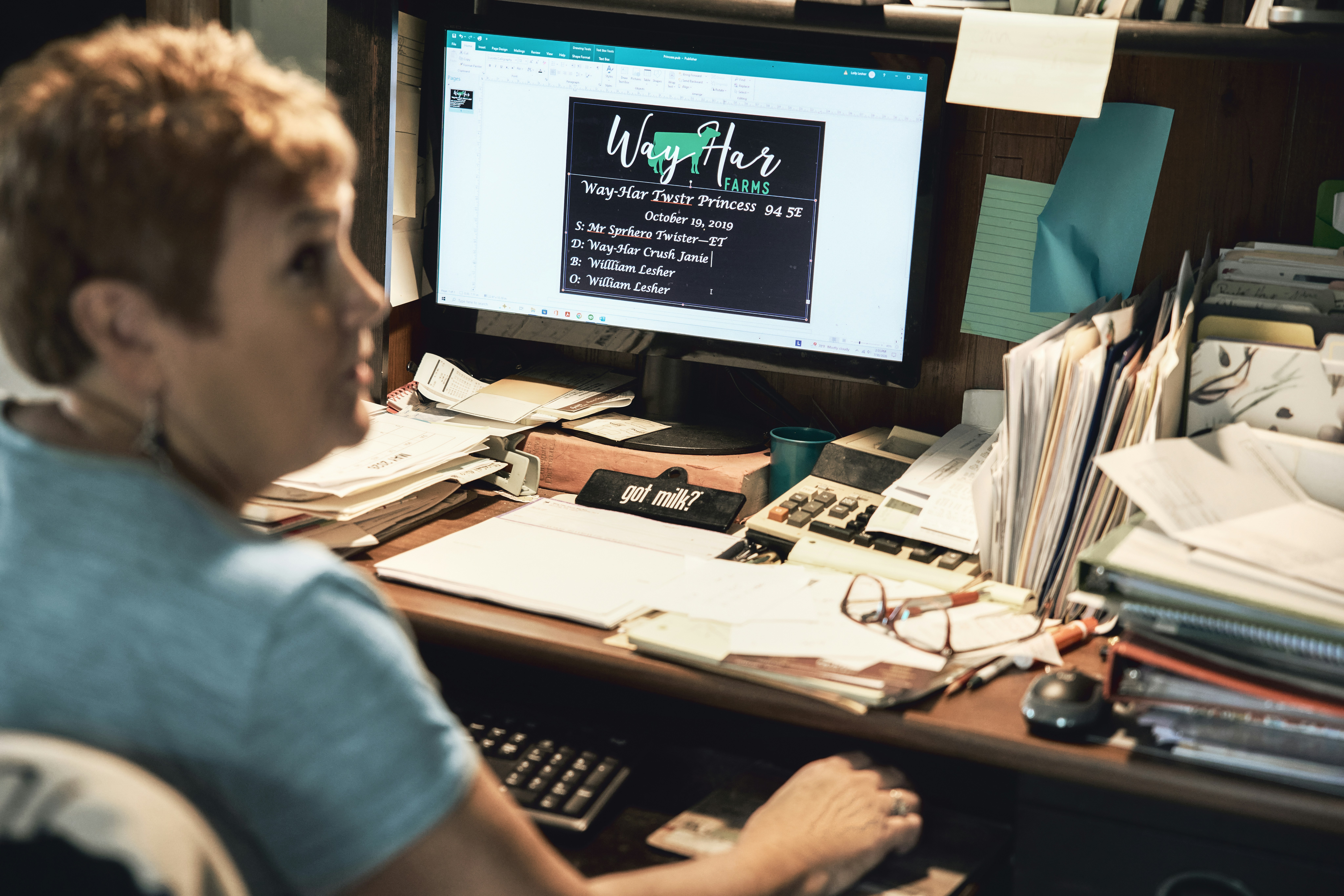 Woman working at a farm office desk. Pennsylvania, USA.