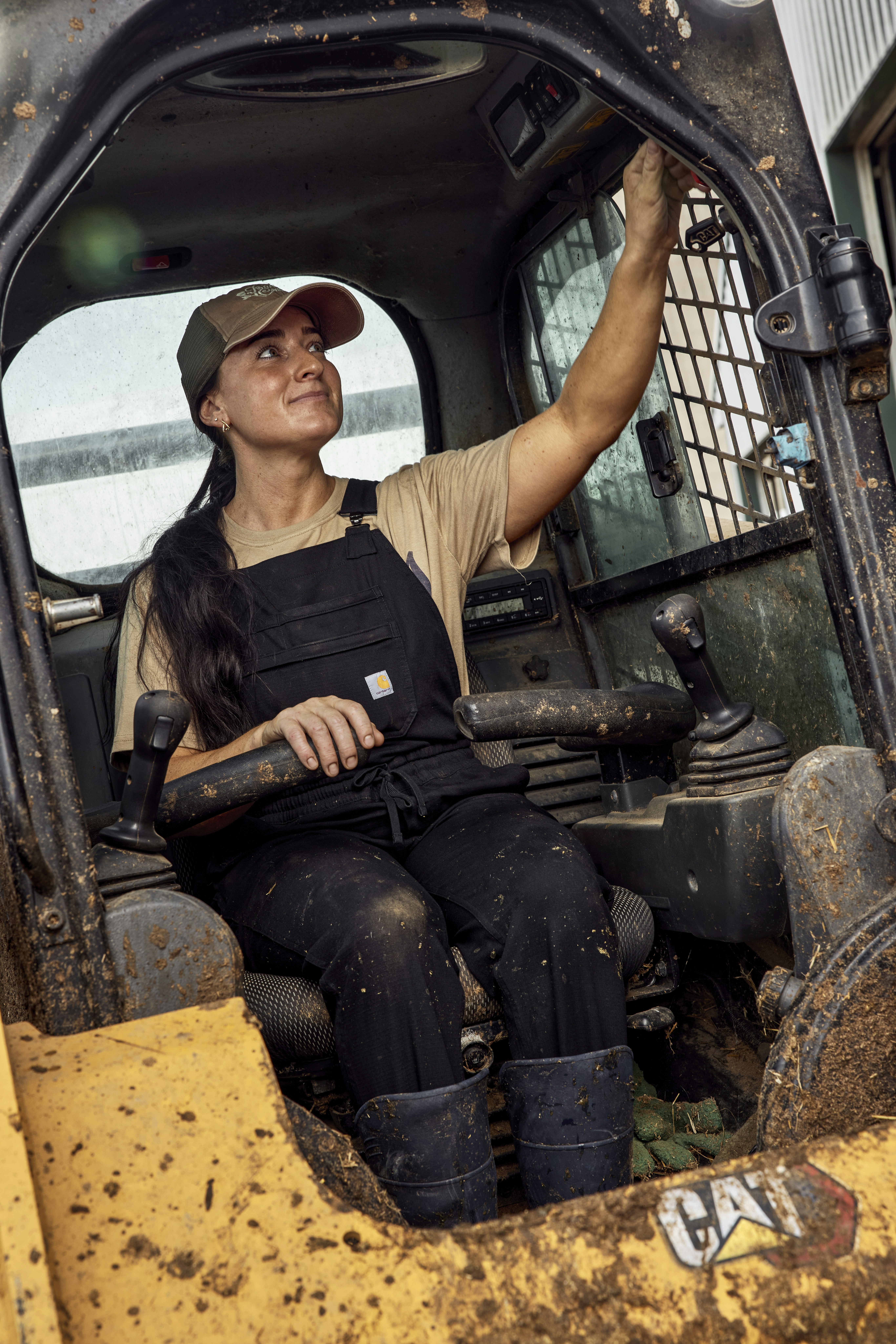Woman at the controls of a skid steer. Ohio, USA.