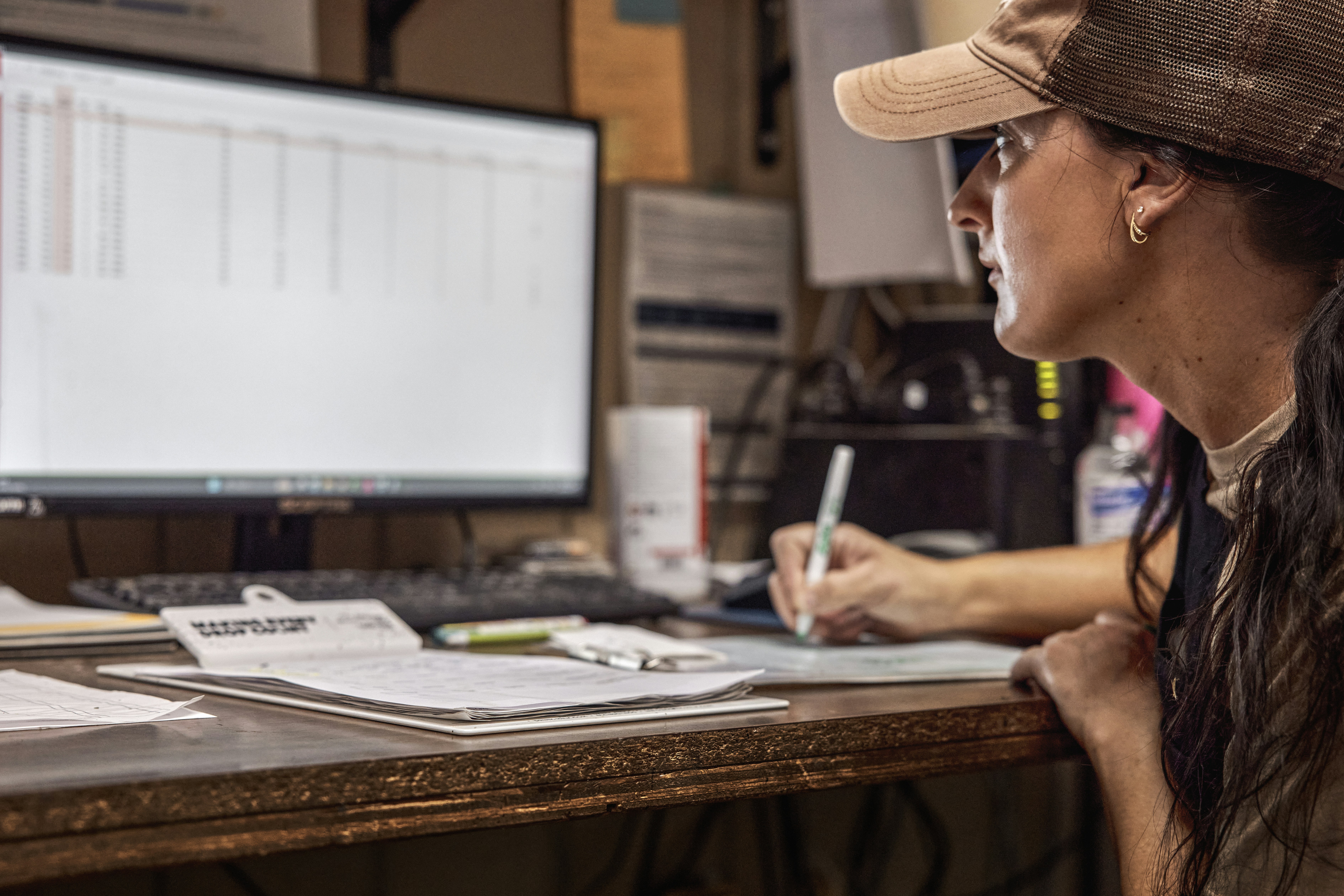Woman working at a farm office computer. Ohio, USA.