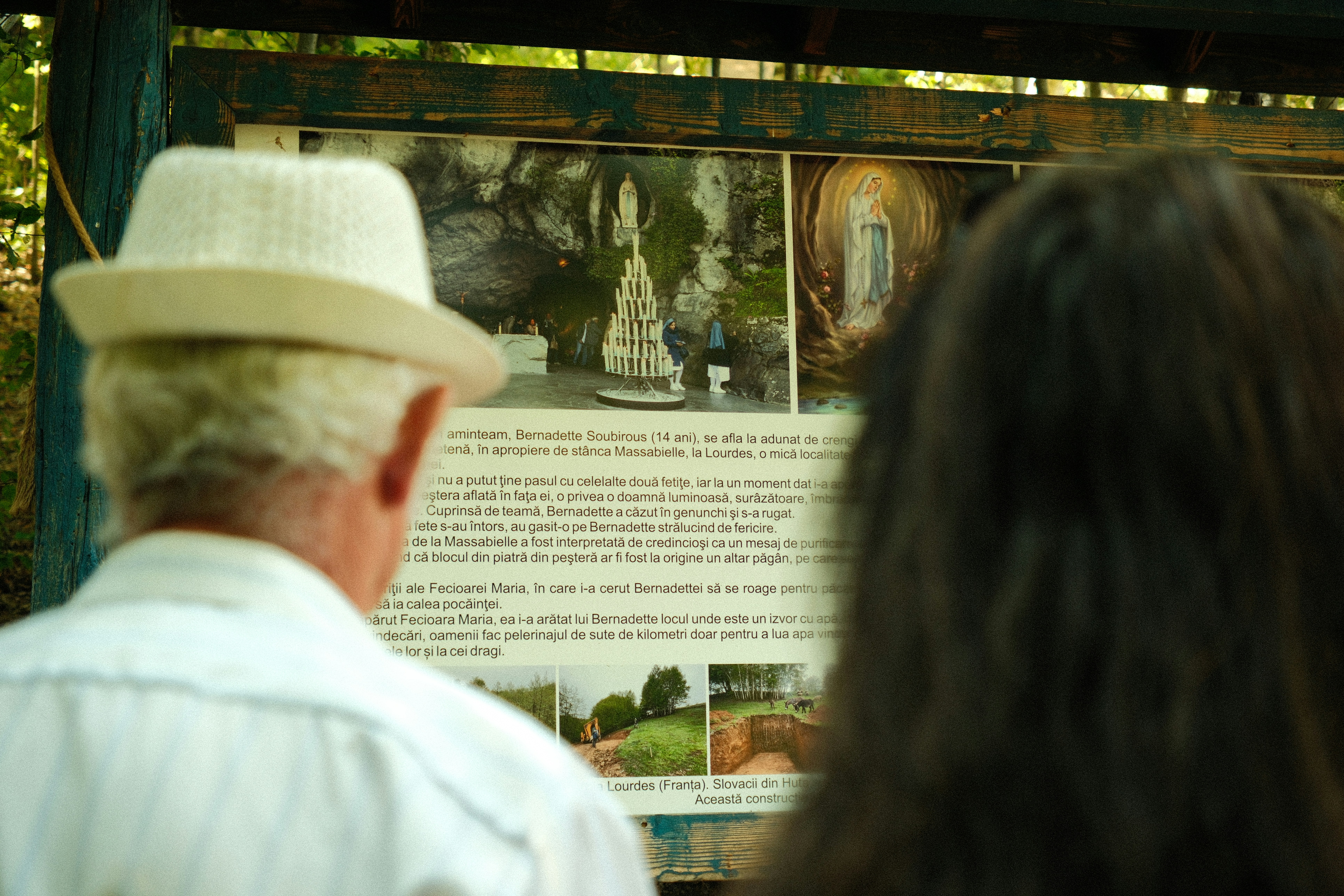 People reading informational sign in Lourdes - Free Photo on Unsplash