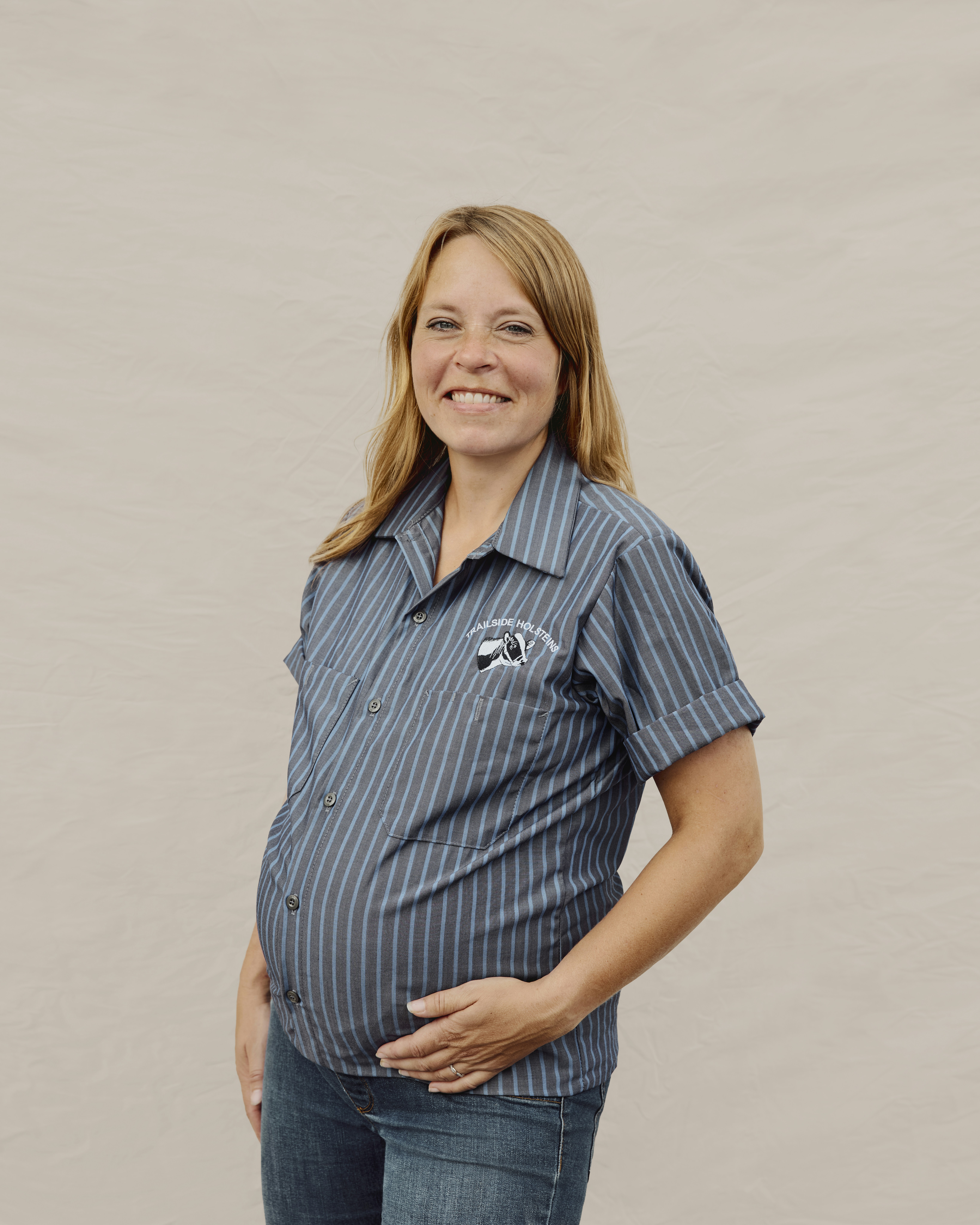 Woman dairy farmer posing in workwear