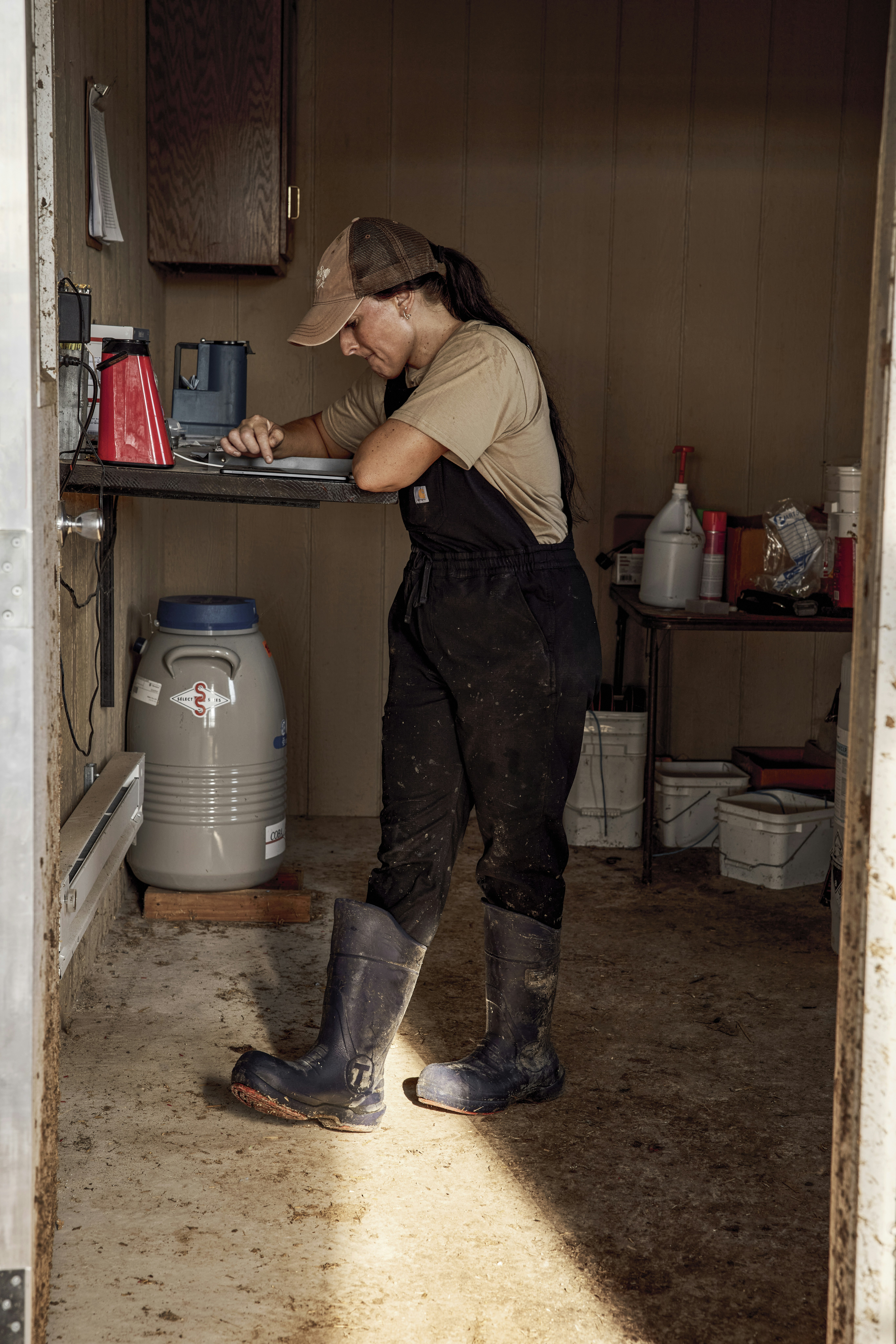 Woman working beside milk containers. Ohio, USA.