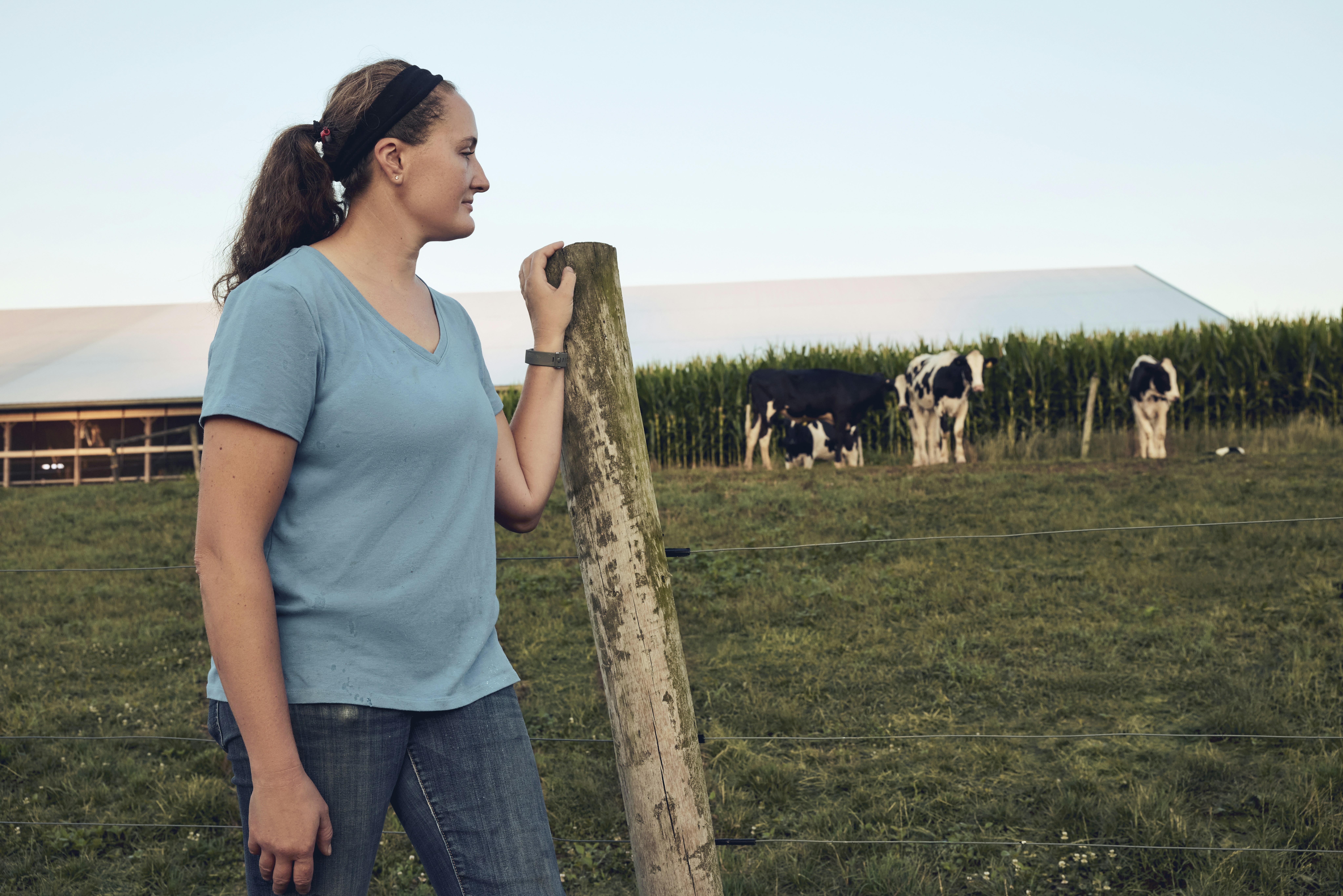 Woman beside a pasture fence