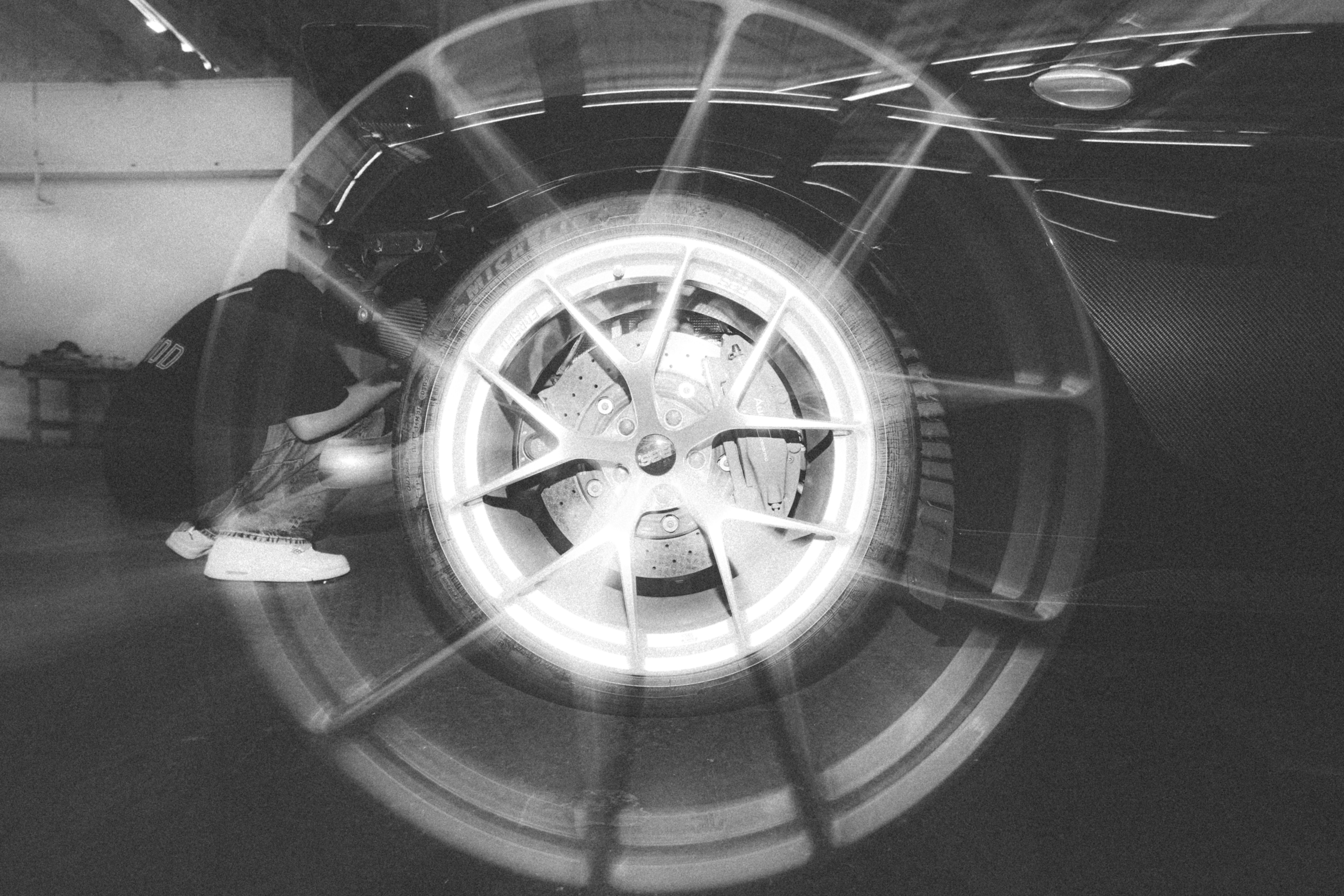 Person crouching beside car wheel - Free Photo on Unsplash
