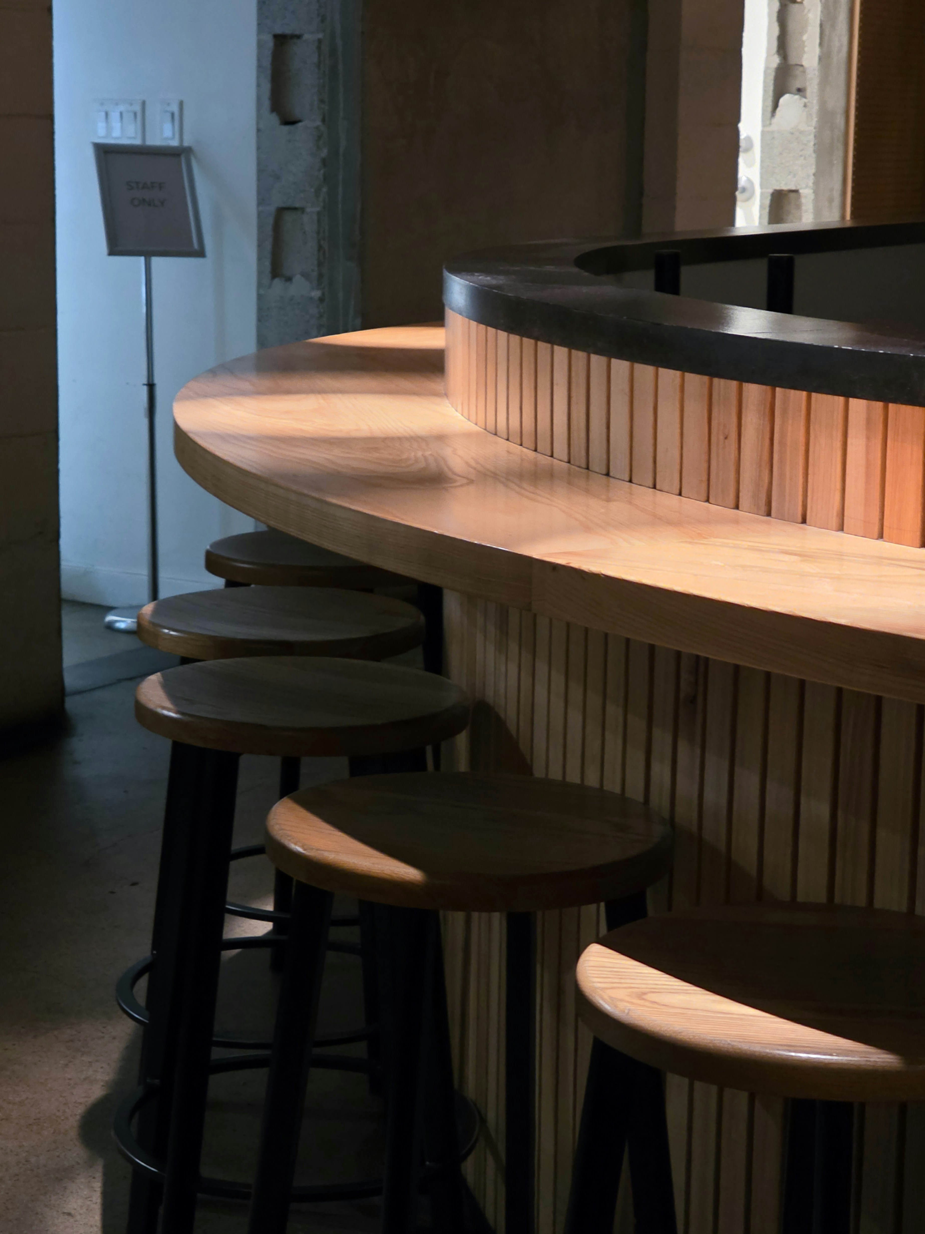 Curved wooden bar with stools - Free Photo on Unsplash