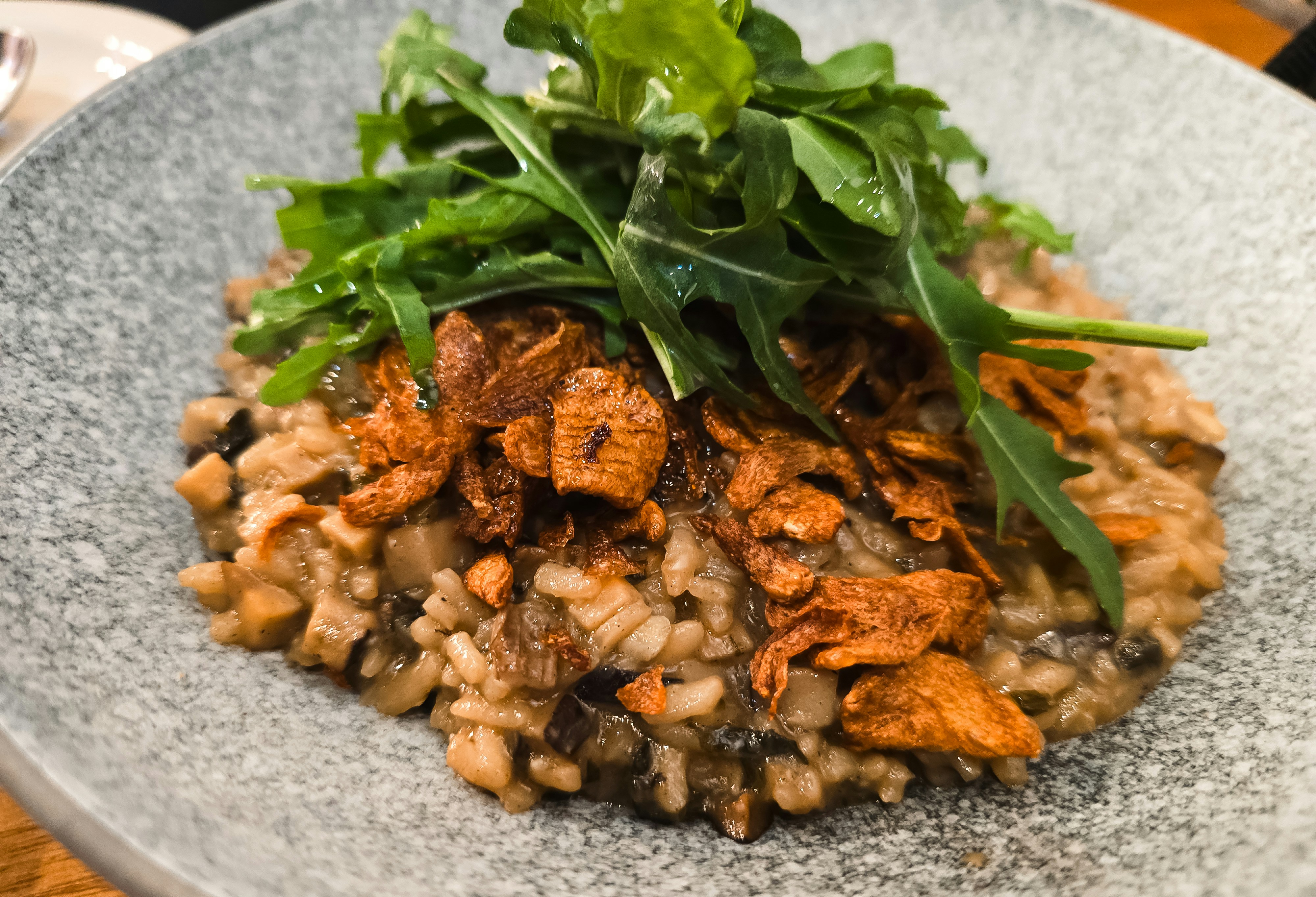 Mushroom risotto topped with greens