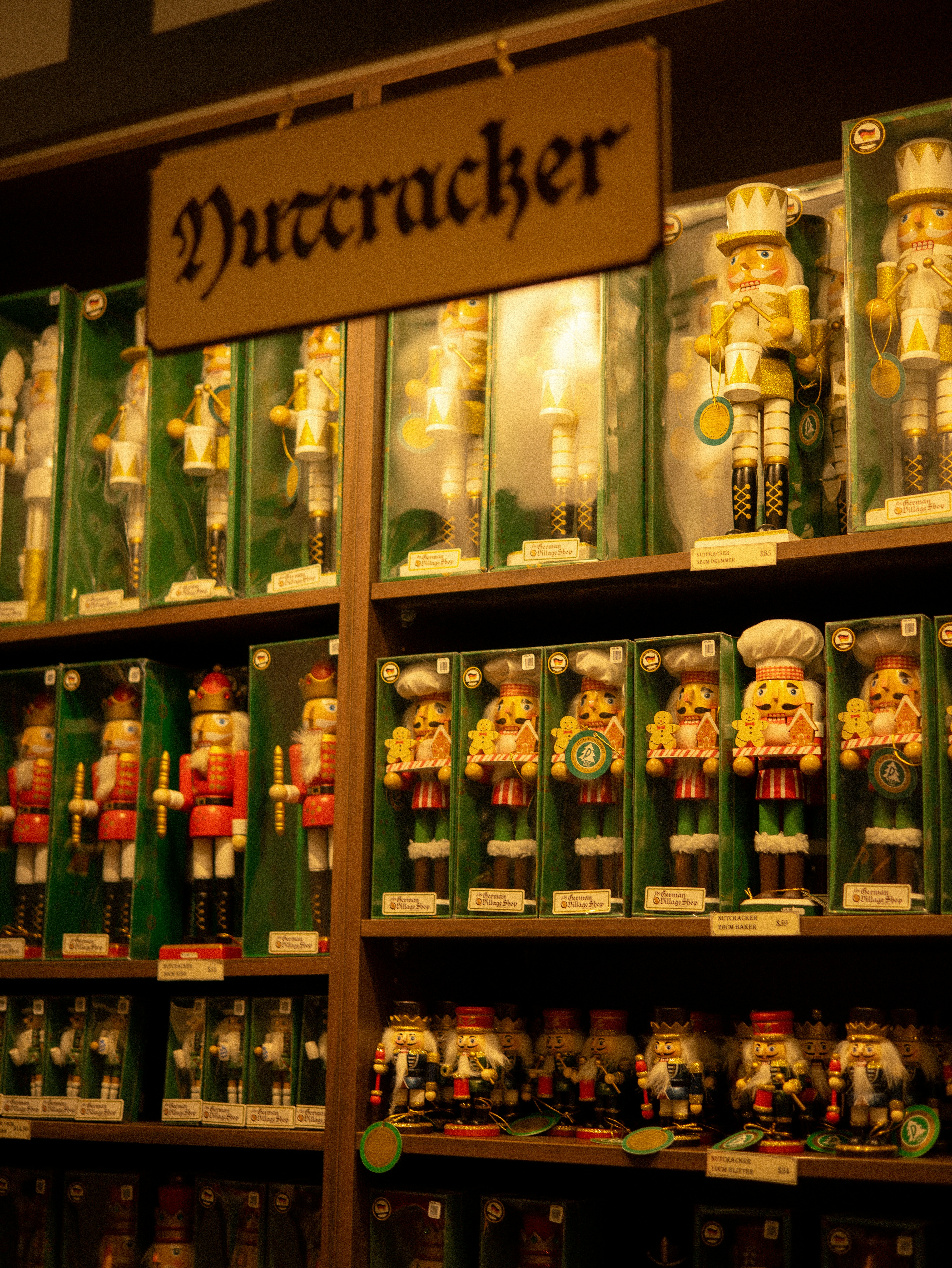 Rows of boxed nutcracker figurines on wooden shelves under a sign reading Nutcracker