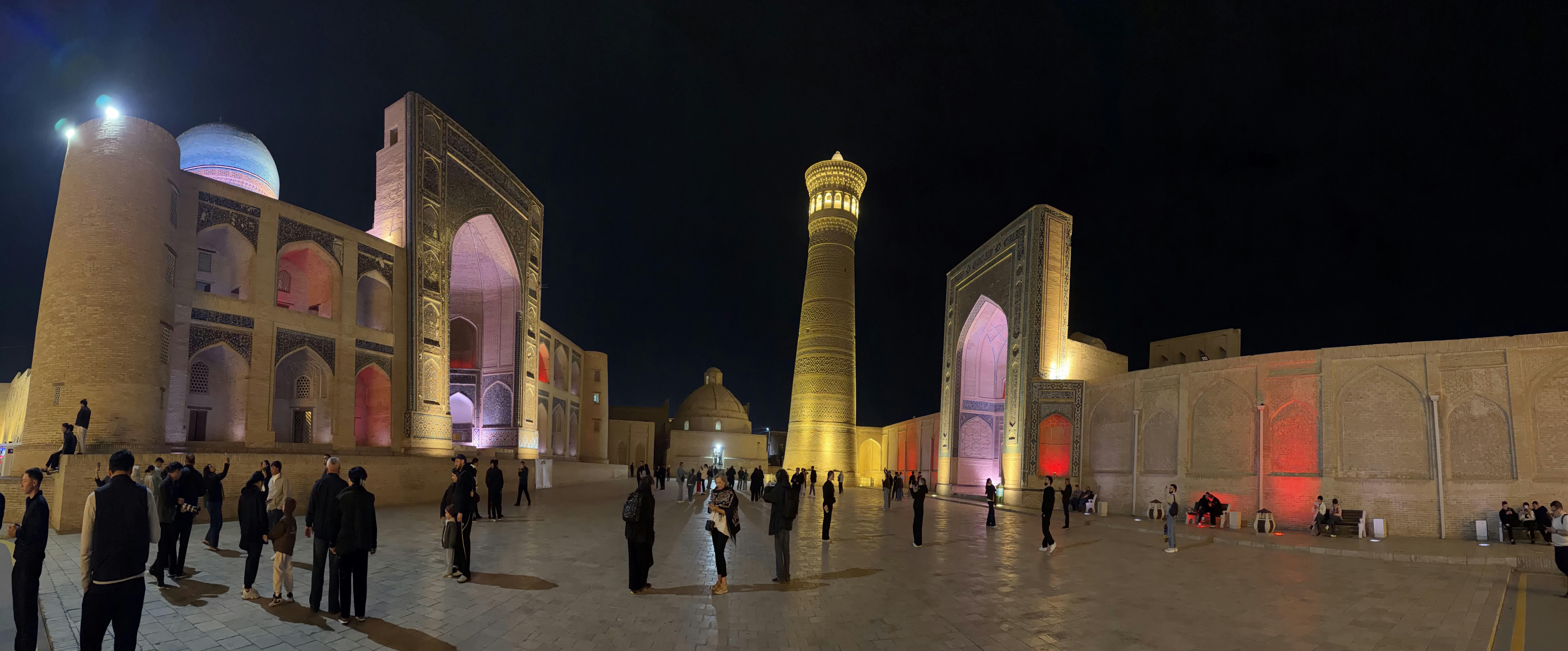 People walking in the Po-i-Kalyan complex at night in Bukhara, Uzbekistan
