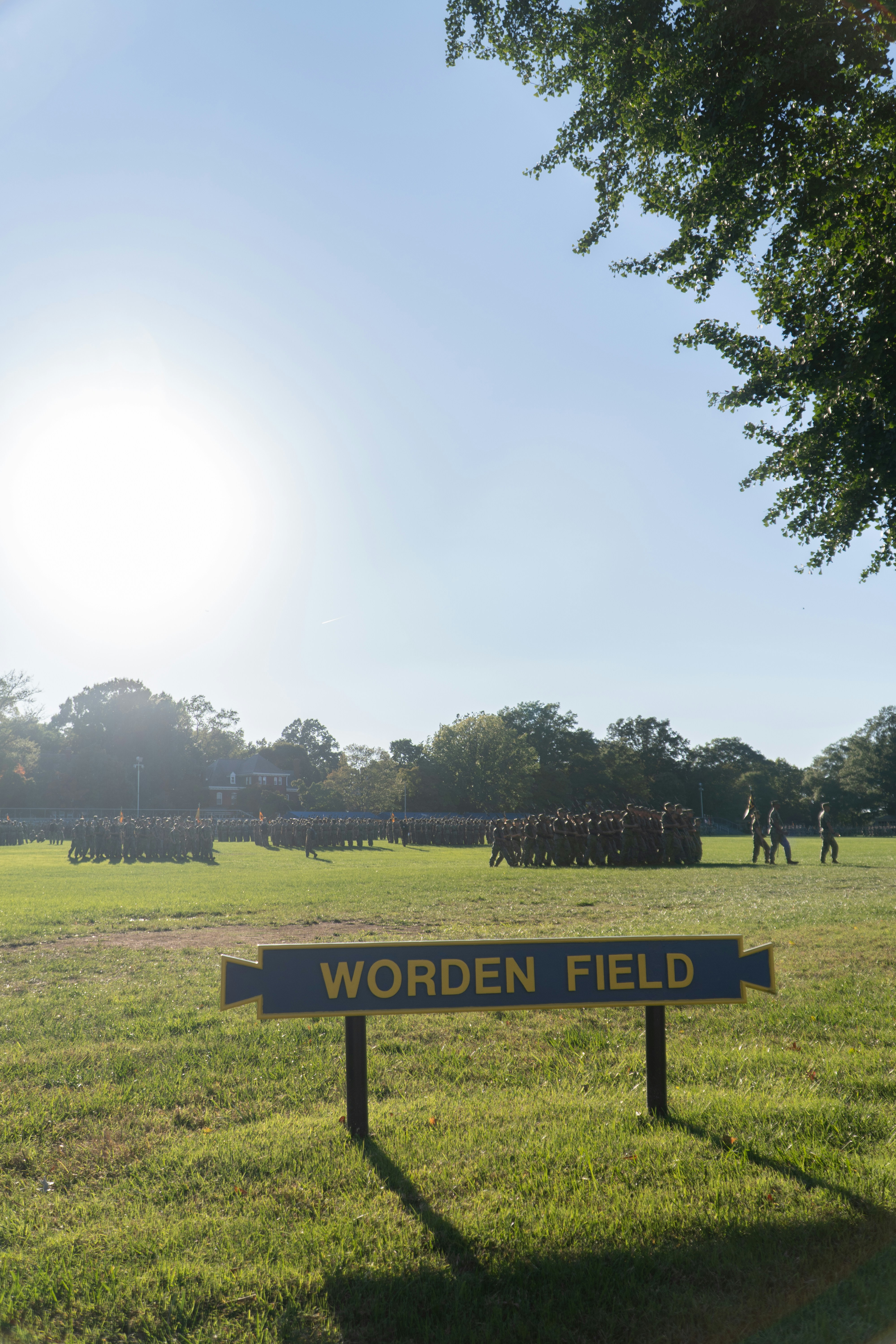 A sign reading WORDEN FIELD in front of a large group of soldiers
