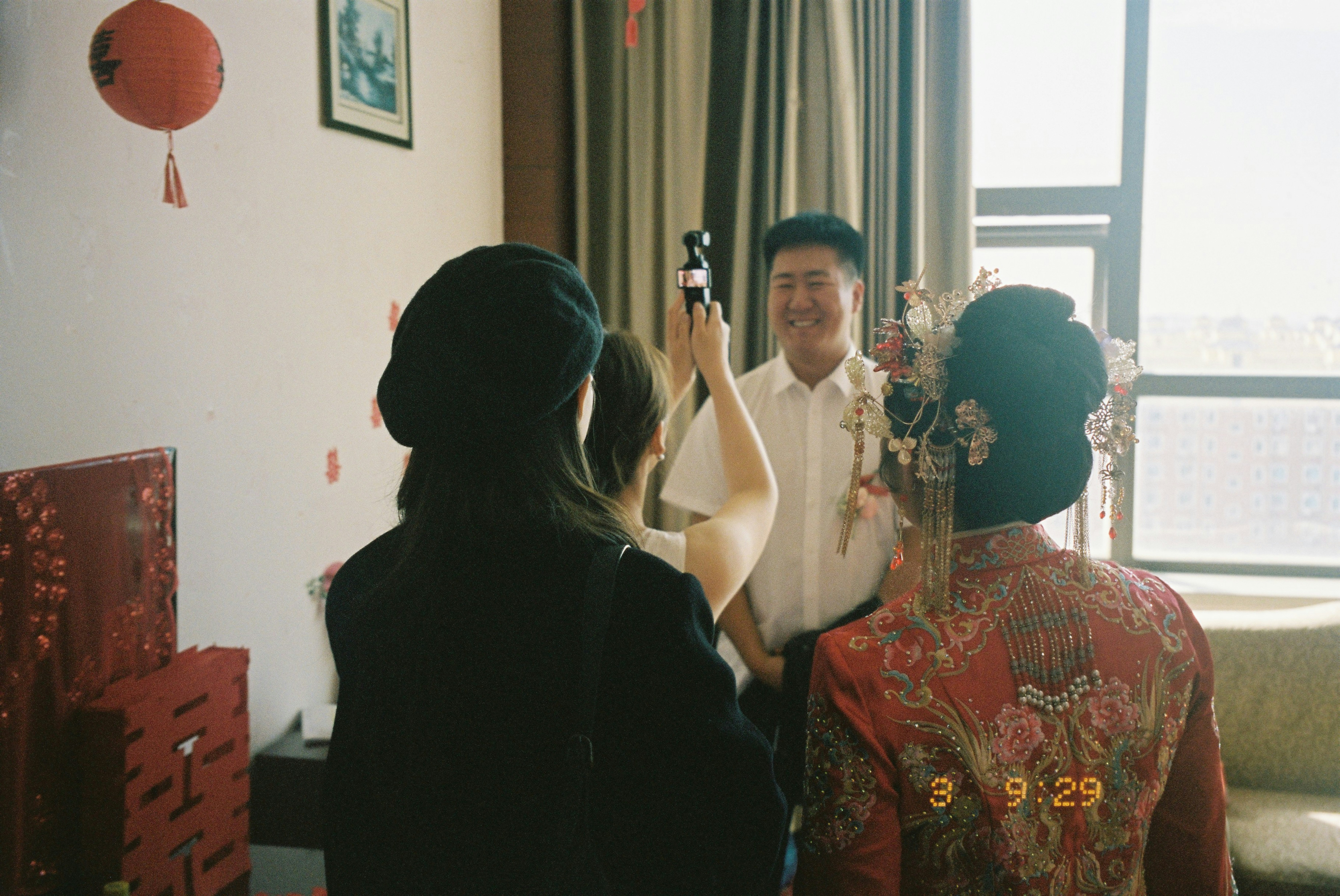 A person filming a smiling man in a white shirt with a gimbal camera