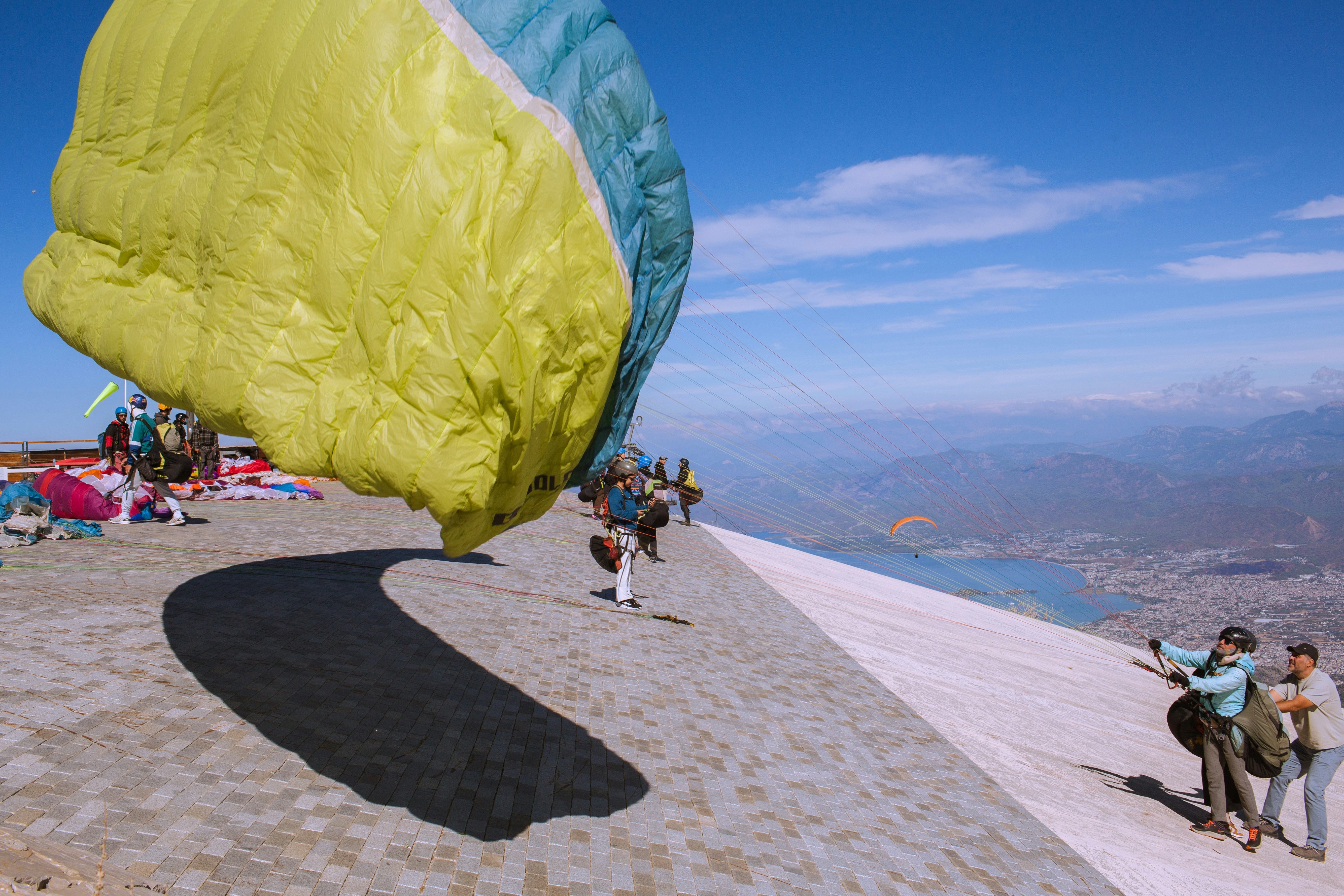 Paragliders on paved mountain ridge - Free Photo on Unsplash