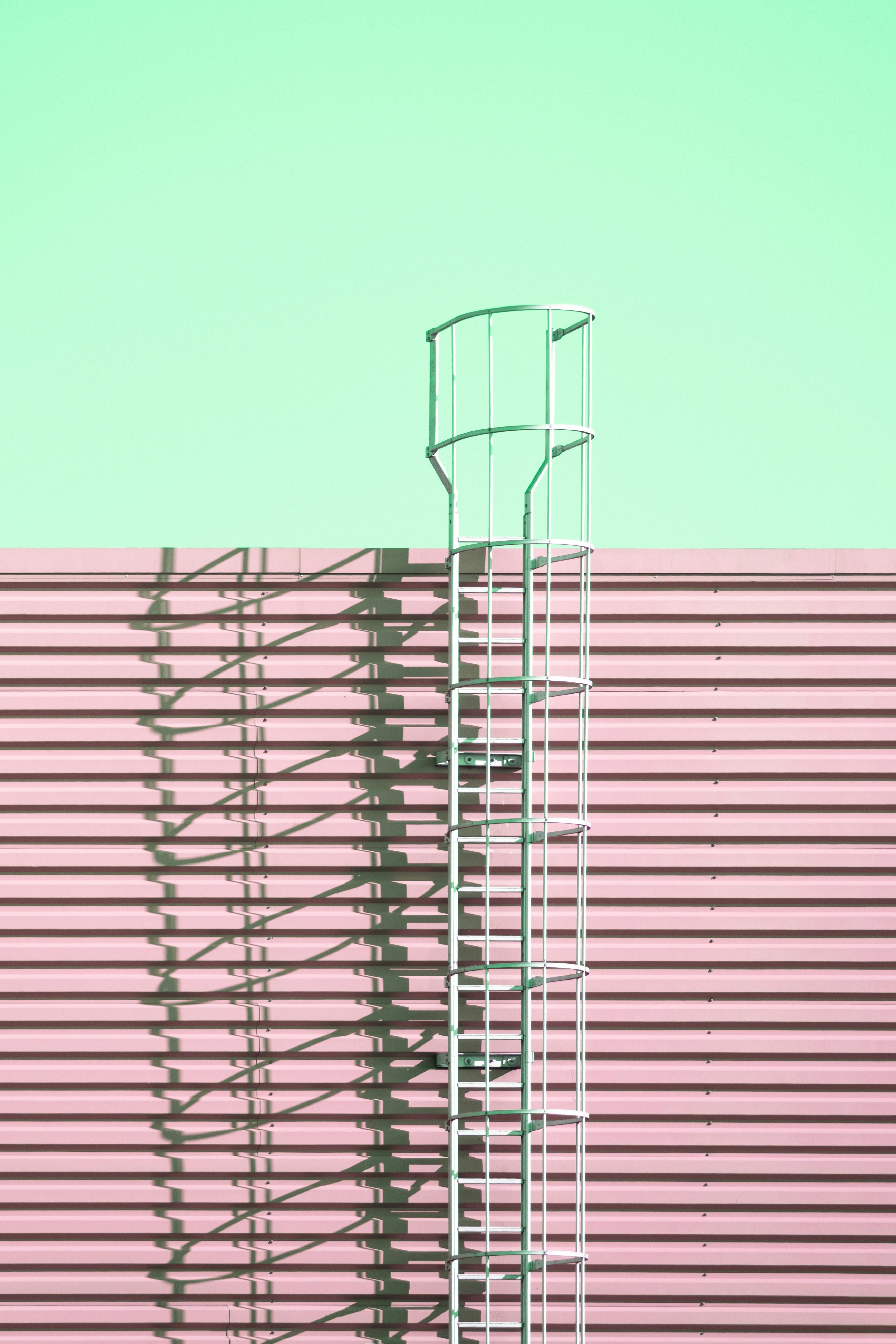 Metal safety ladder on pink wall - Free Photo on Unsplash