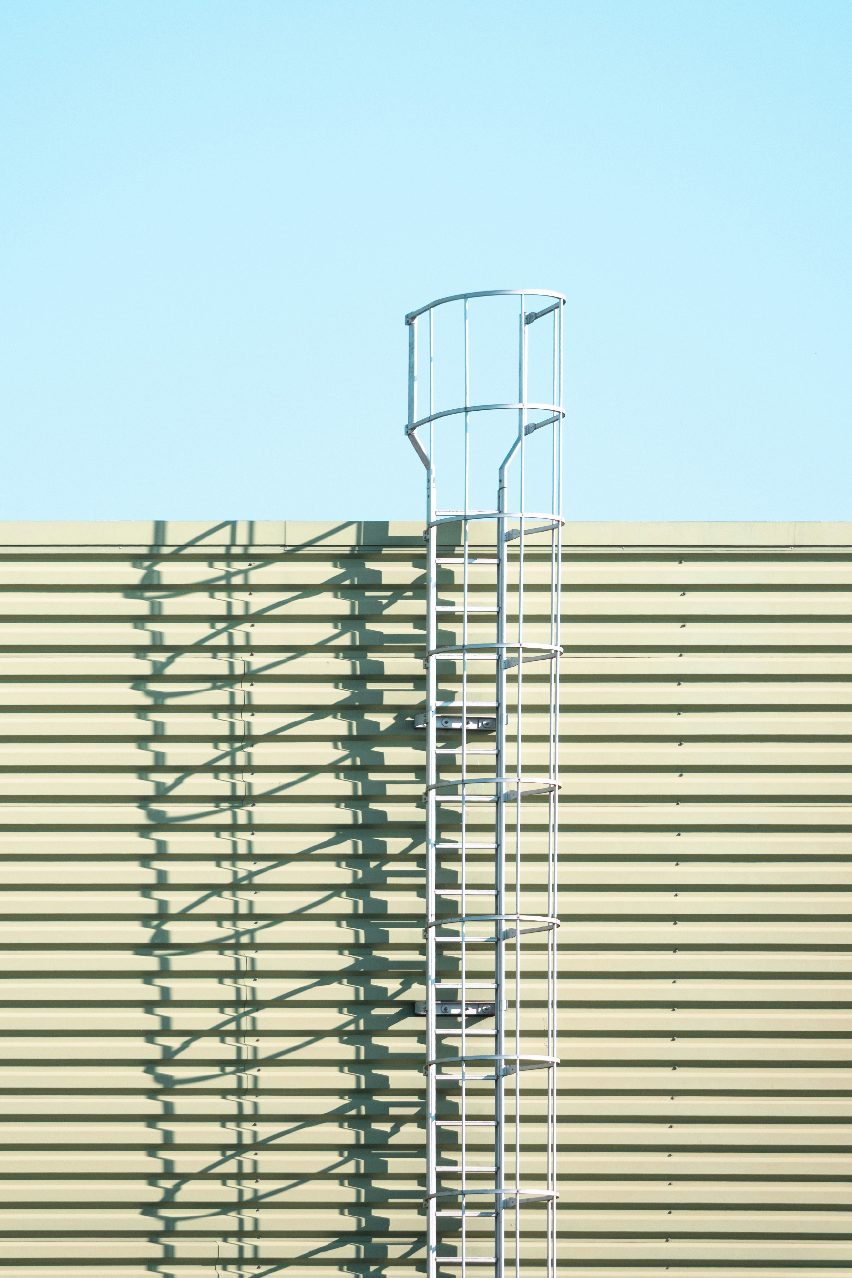 Metal safety ladder on corrugated wall - Free Photo on Unsplash