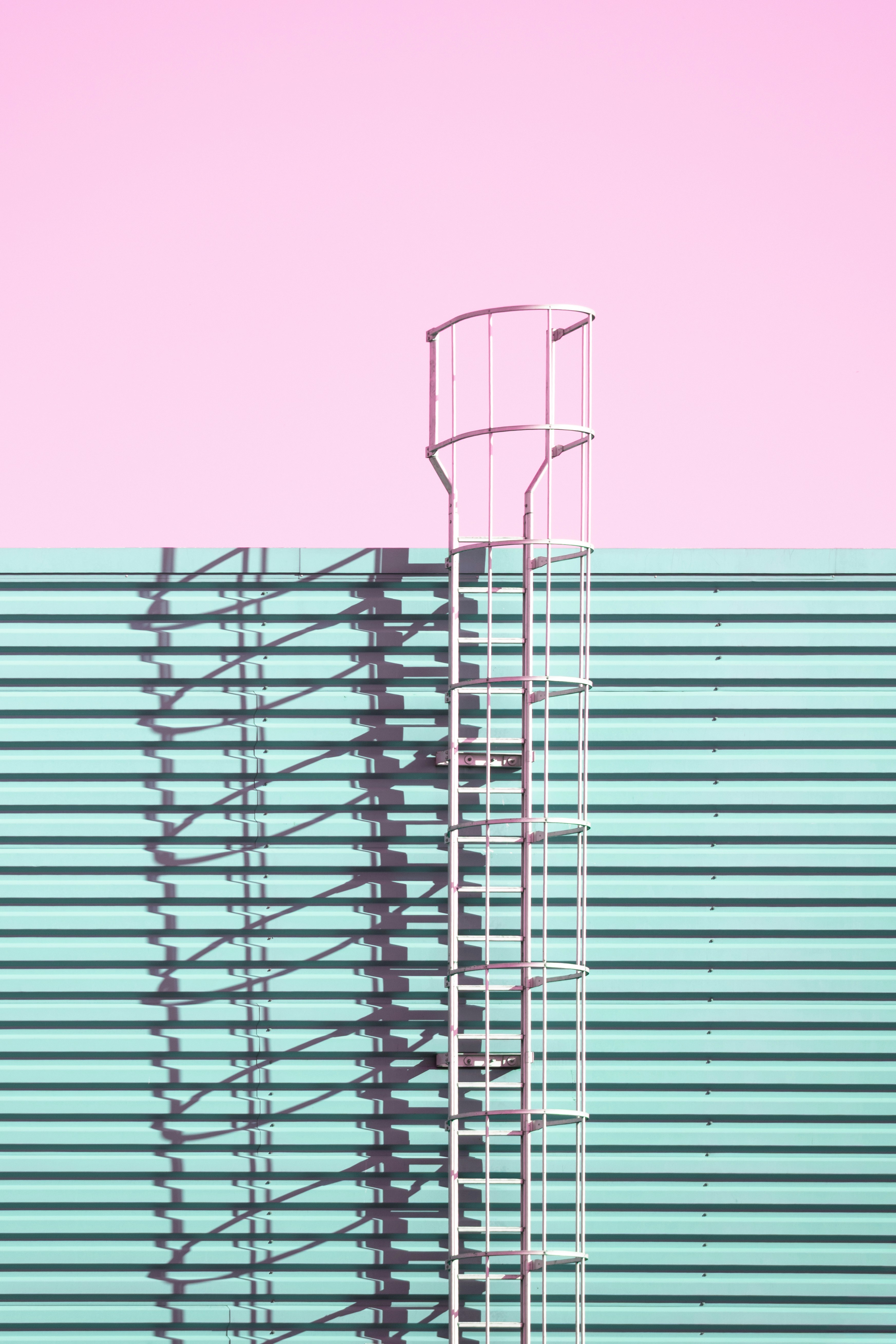 Metal safety ladder on teal wall - Free Photo on Unsplash