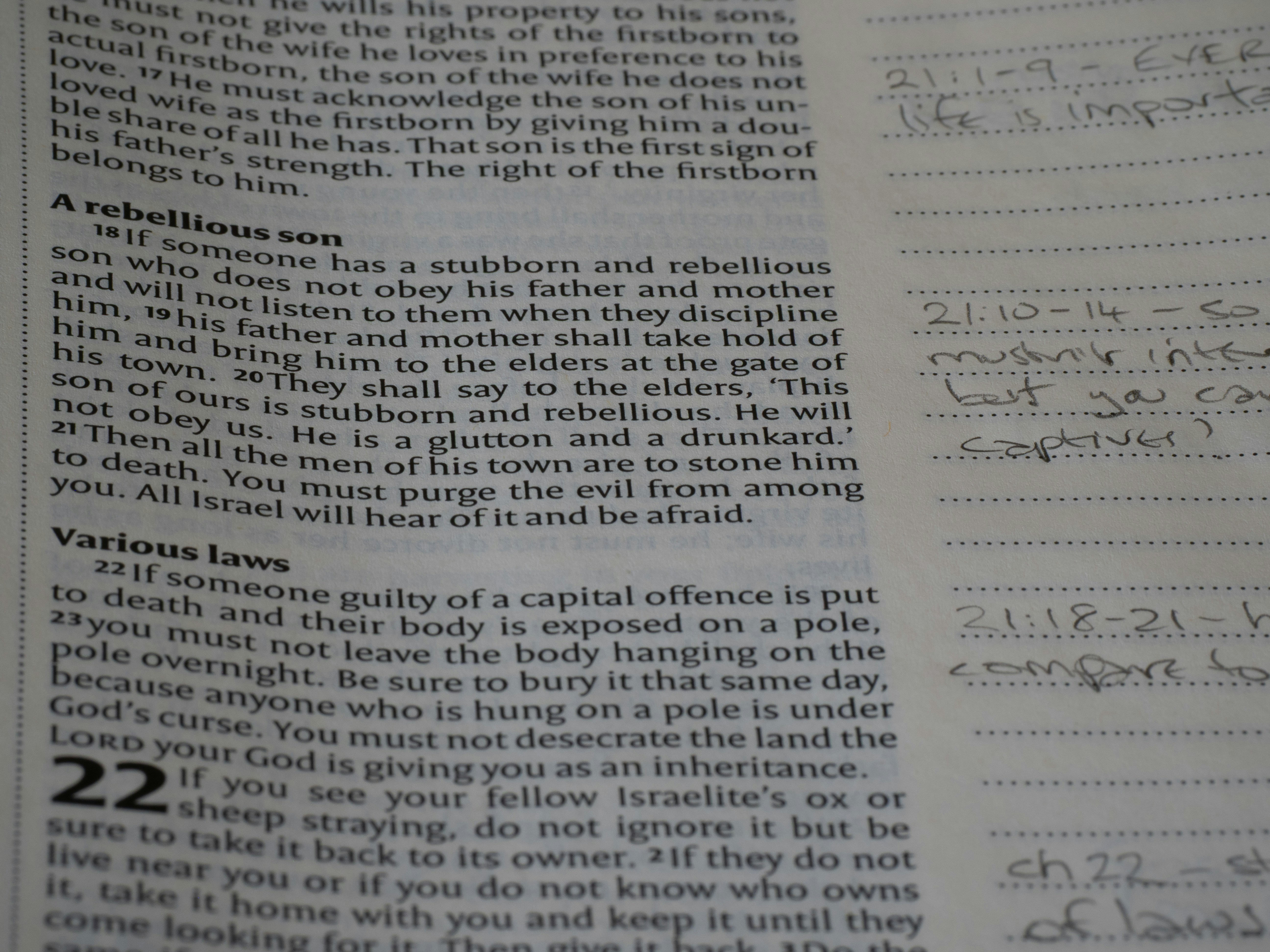 A page of a printed book with biblical text and handwritten notes in the margin