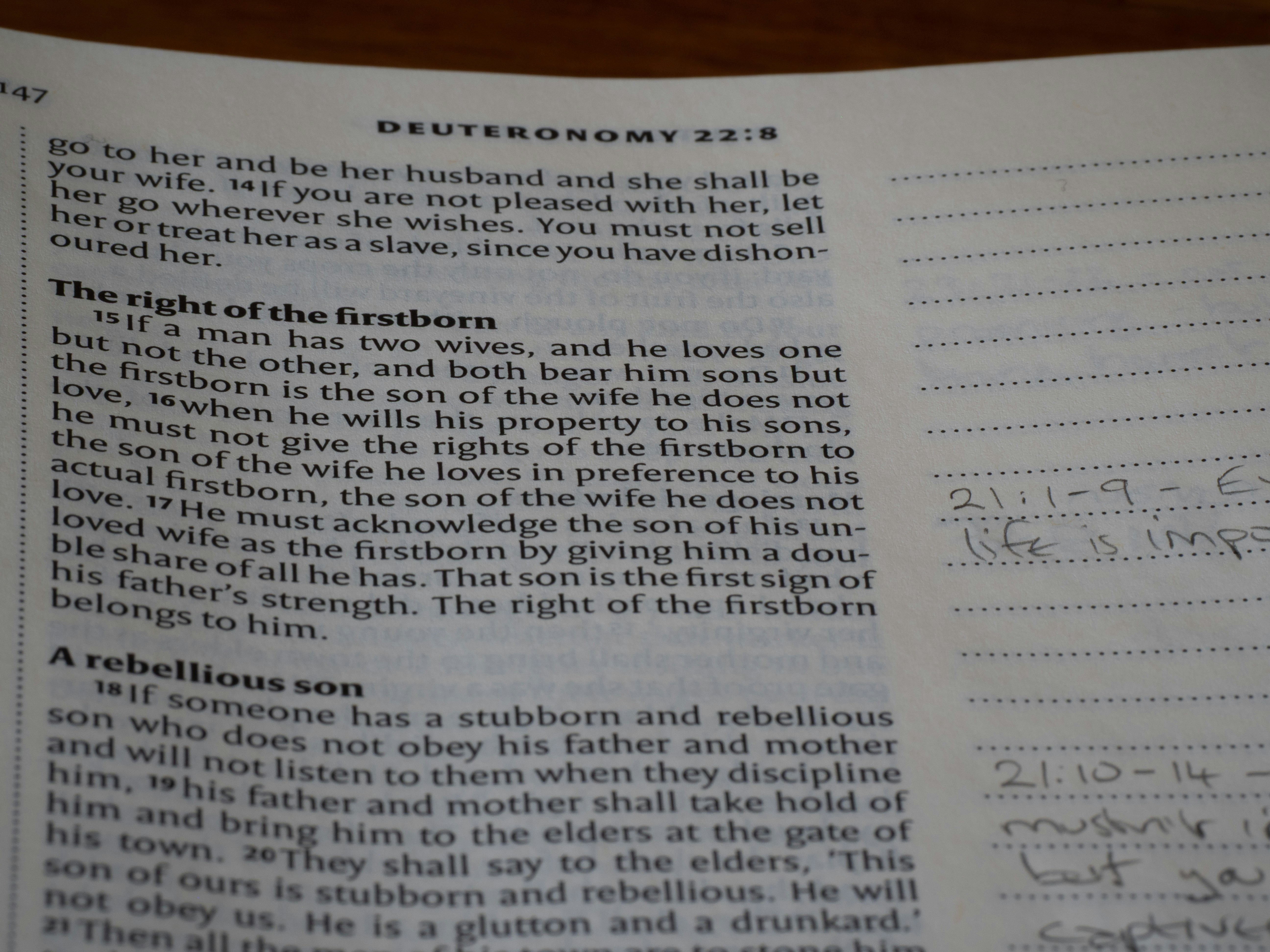 A close-up of a page from the book of Deuteronomy in a Bible with handwritten notes