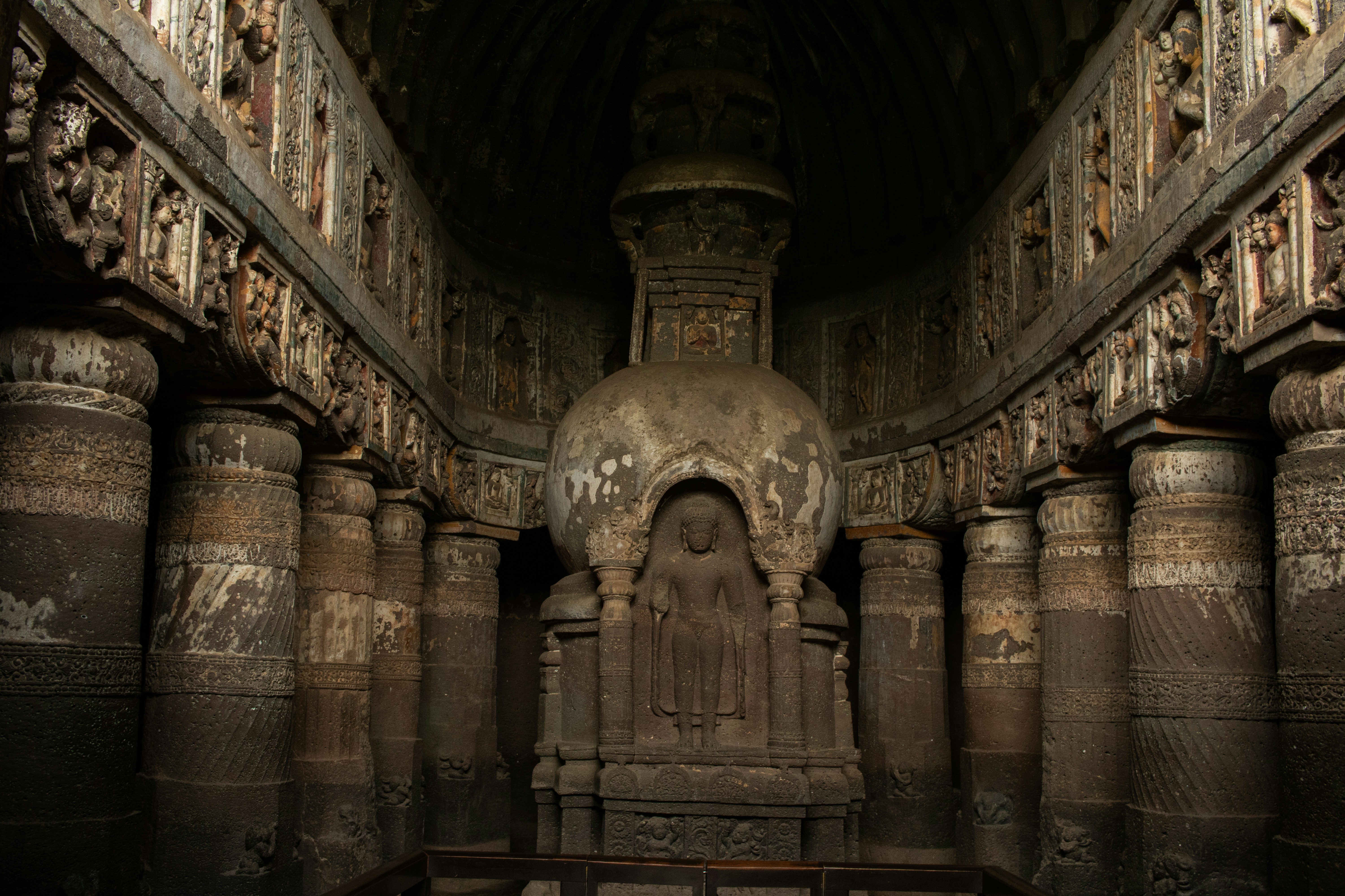 The ornate stone stupa and carved pillars inside Cave 19 at the Ajanta Caves in Maharashtra, India