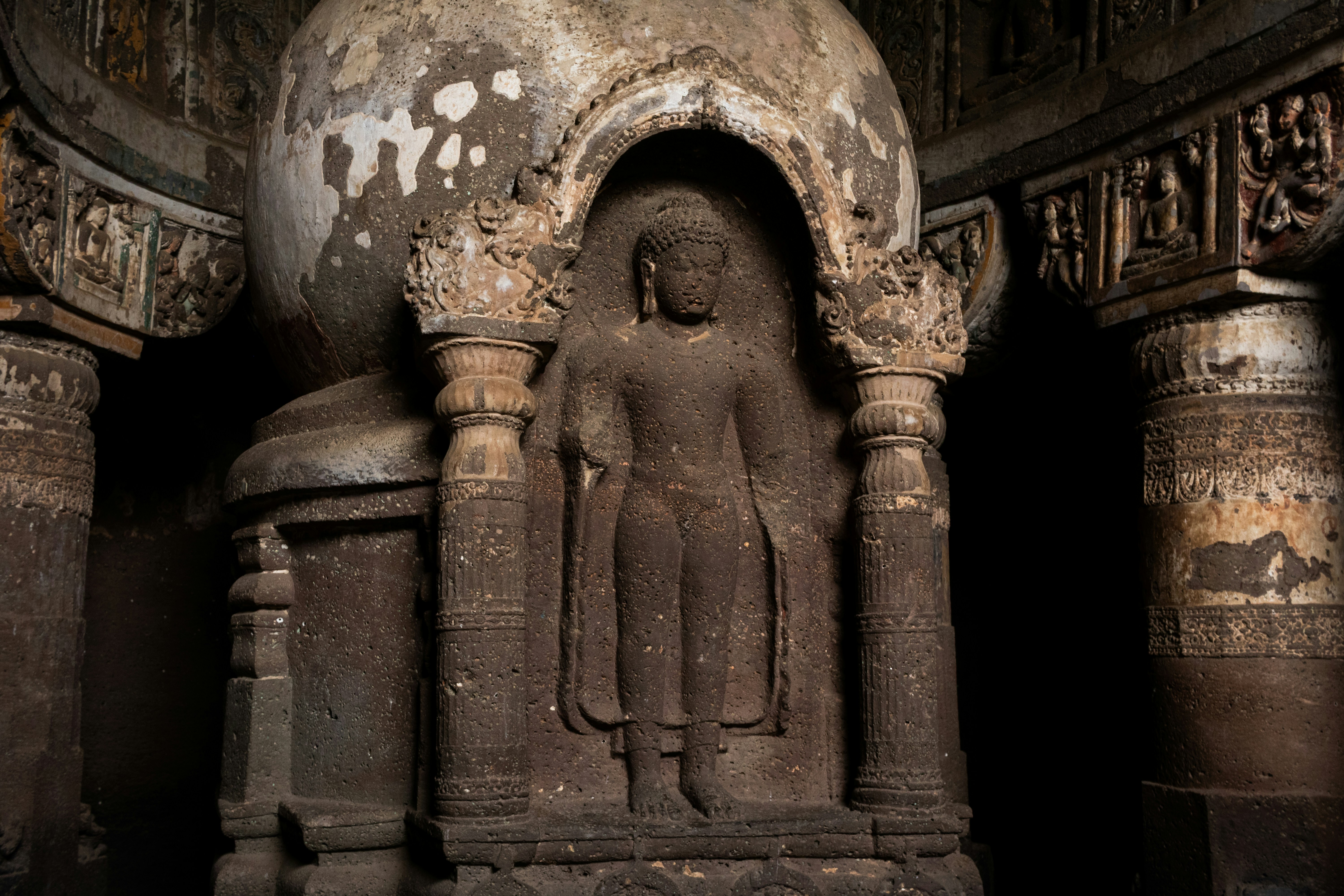 A stone Buddha statue carved into a stupa inside Cave 19 at the Ajanta Caves in India