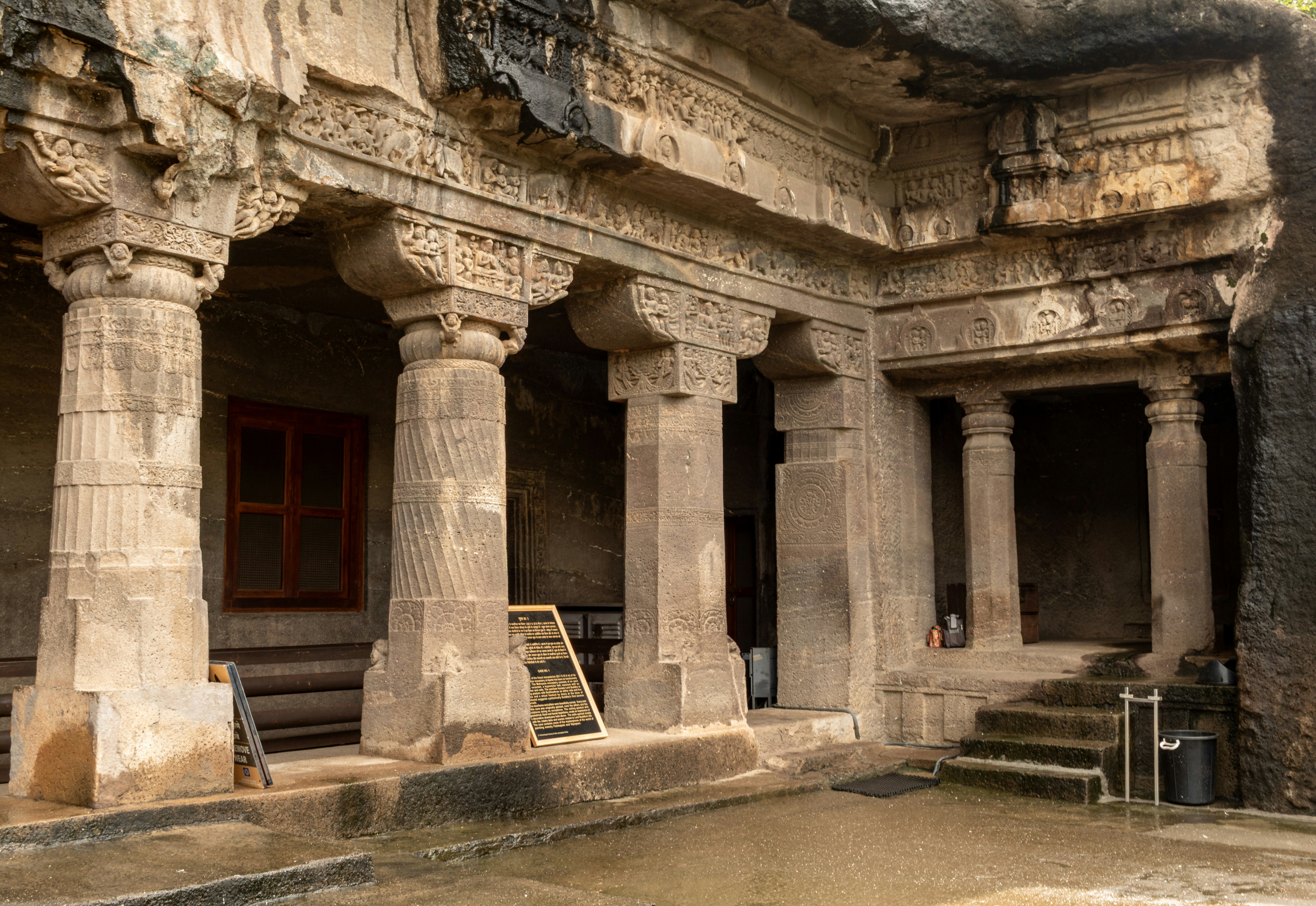 The carved stone pillars and ornate facade of Cave 1 at the Ajanta Caves in Maharashtra, India