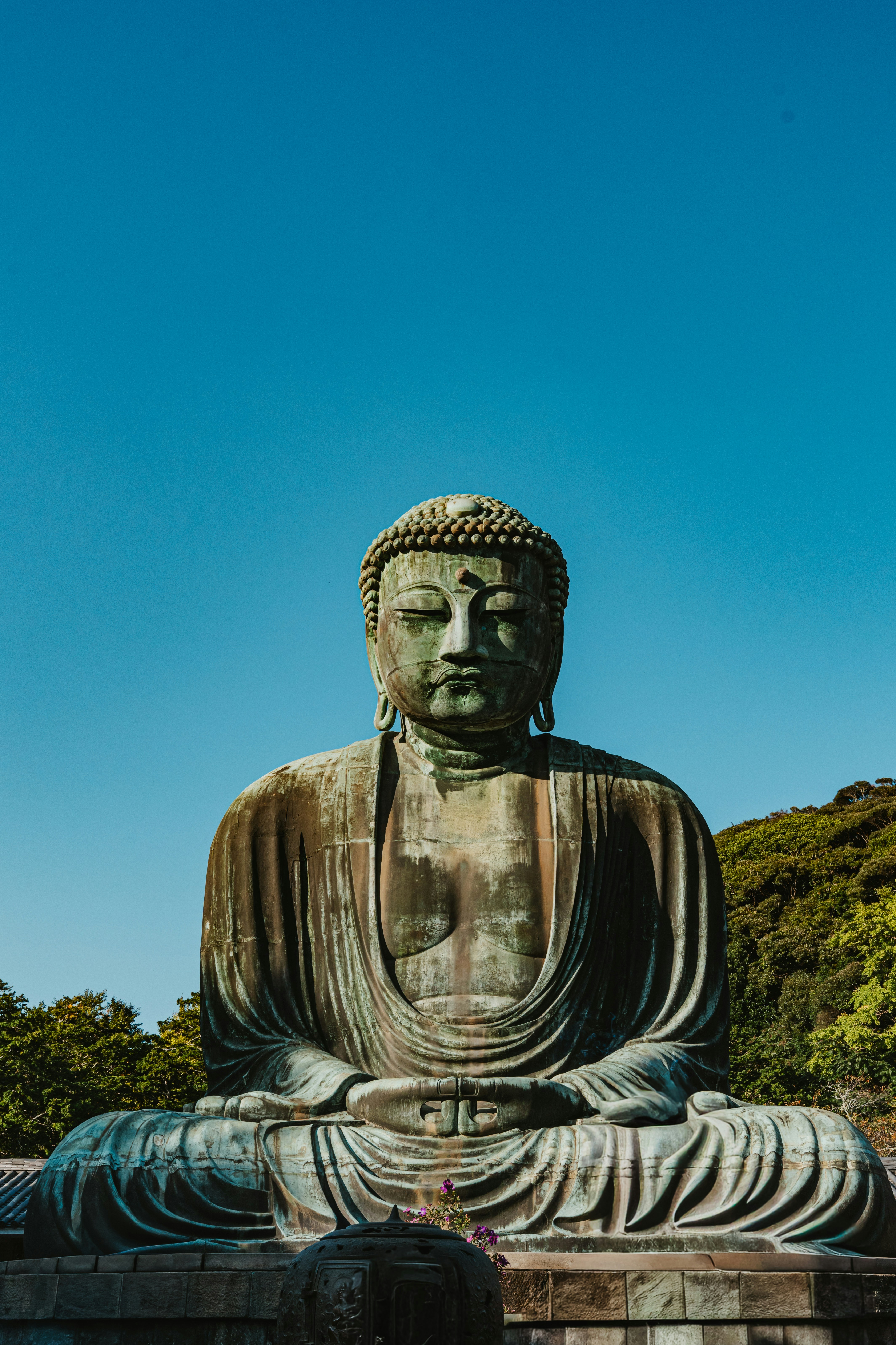 The Great Buddha statue in Kamakura against a clear blue sky