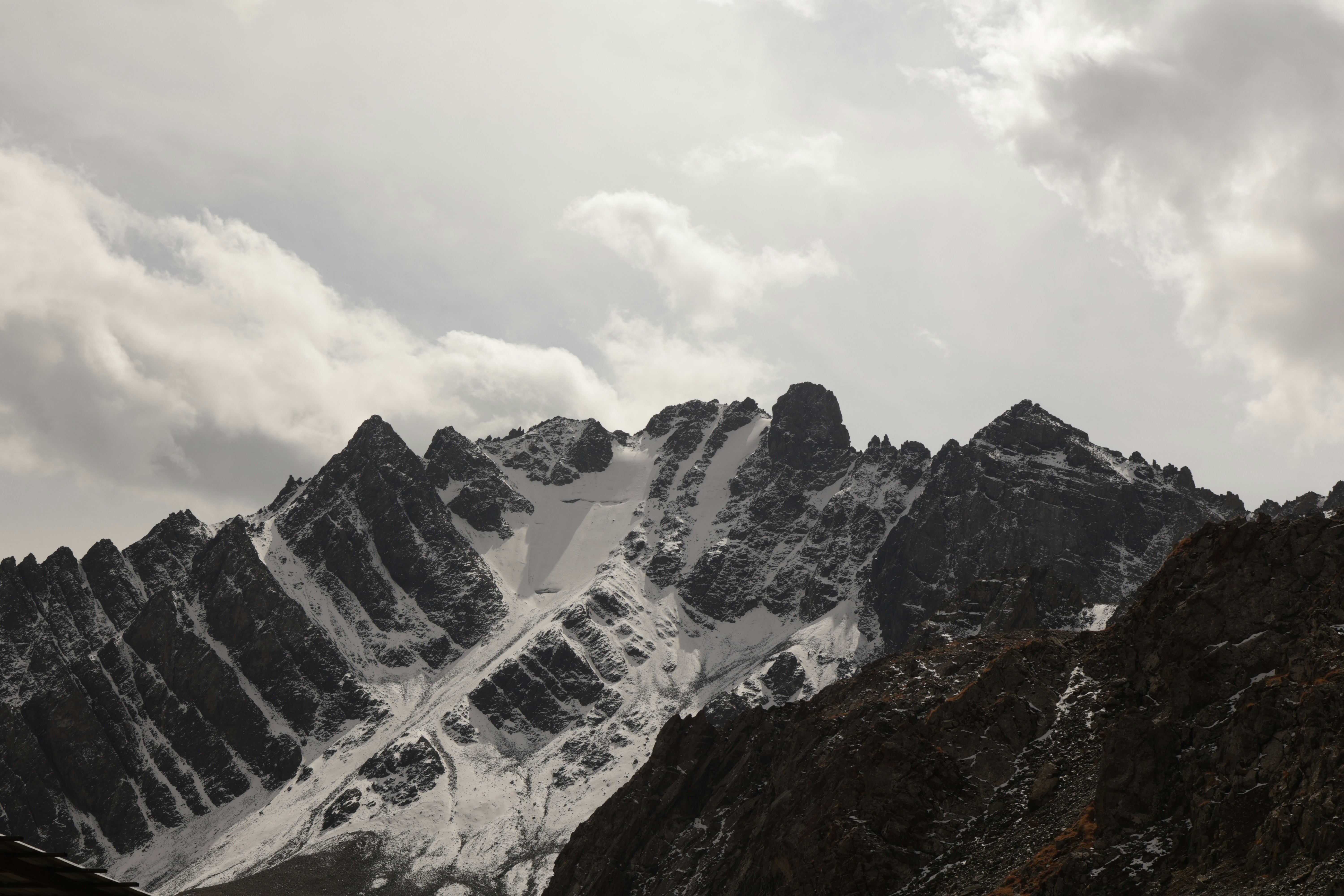 Snowy mountain peaks under cloudy sky - Free Photo on Unsplash