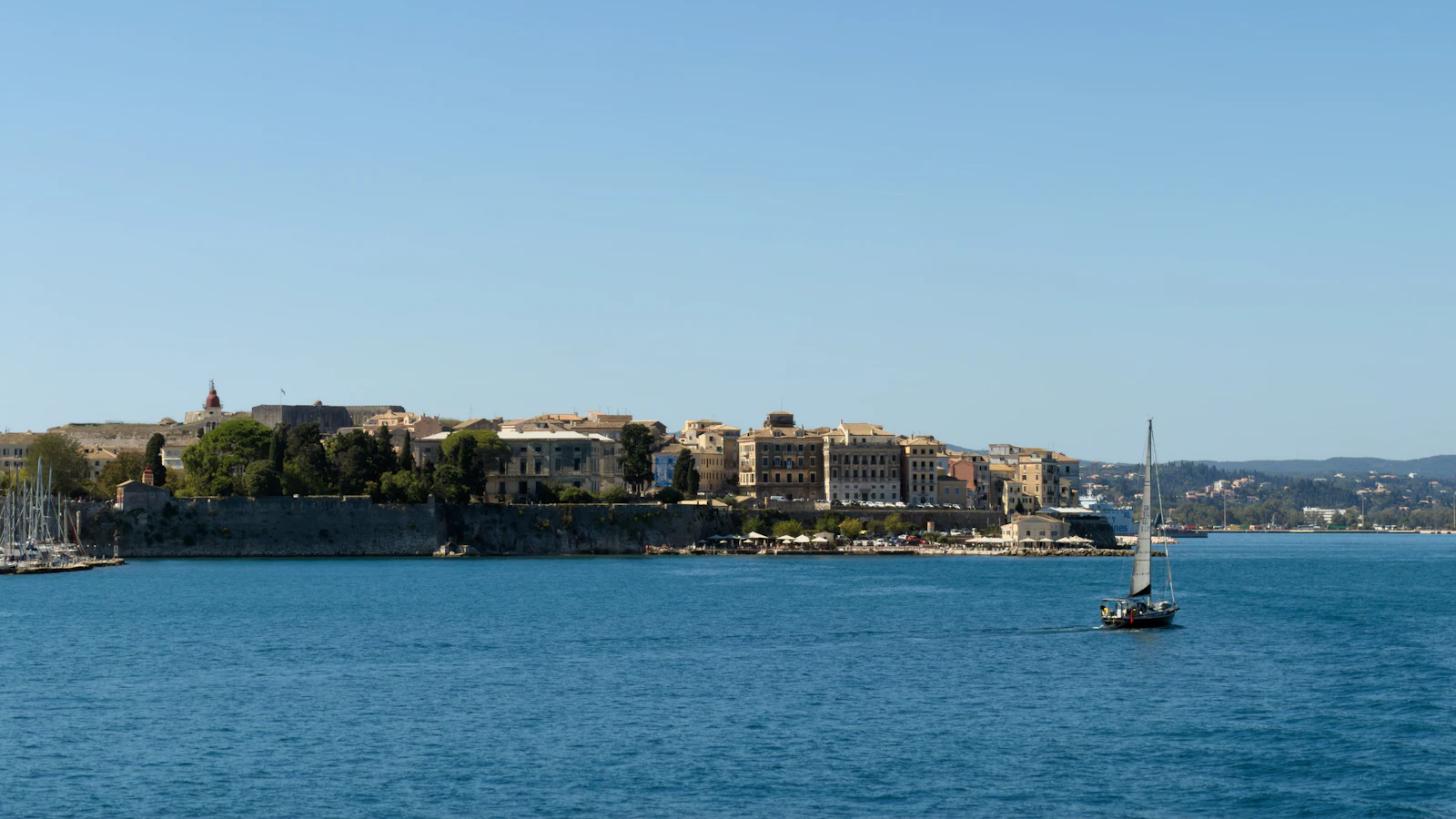 Sailing yacht off Corfu old town