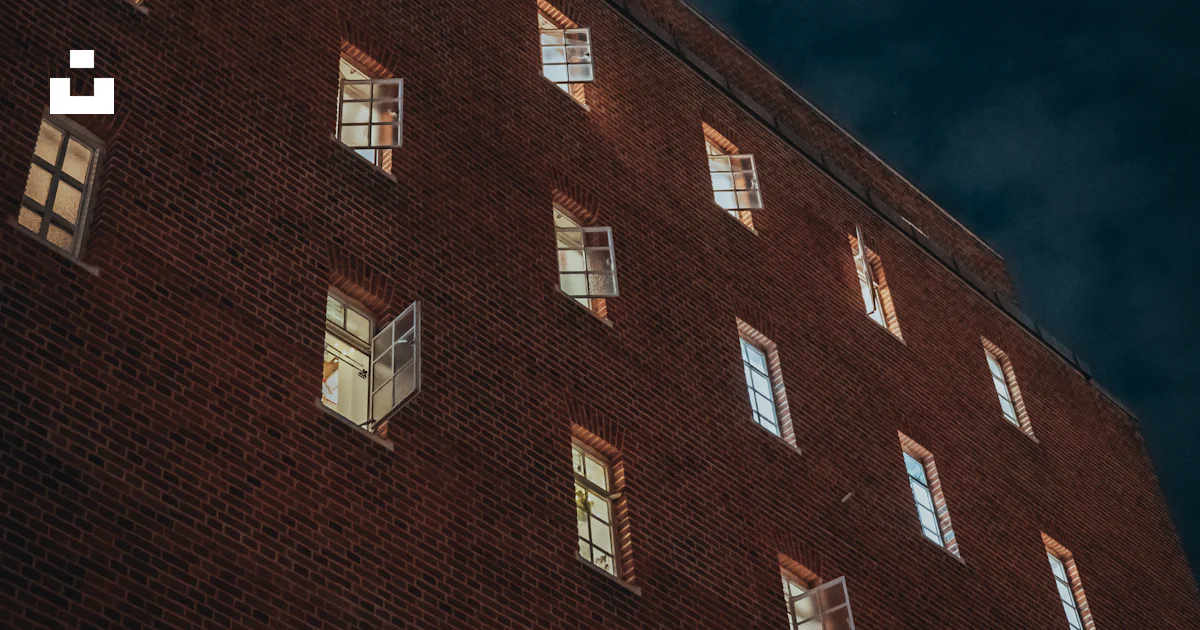 Building Farcade Brick building facade with glowing windows - Free Photo on Unsplash