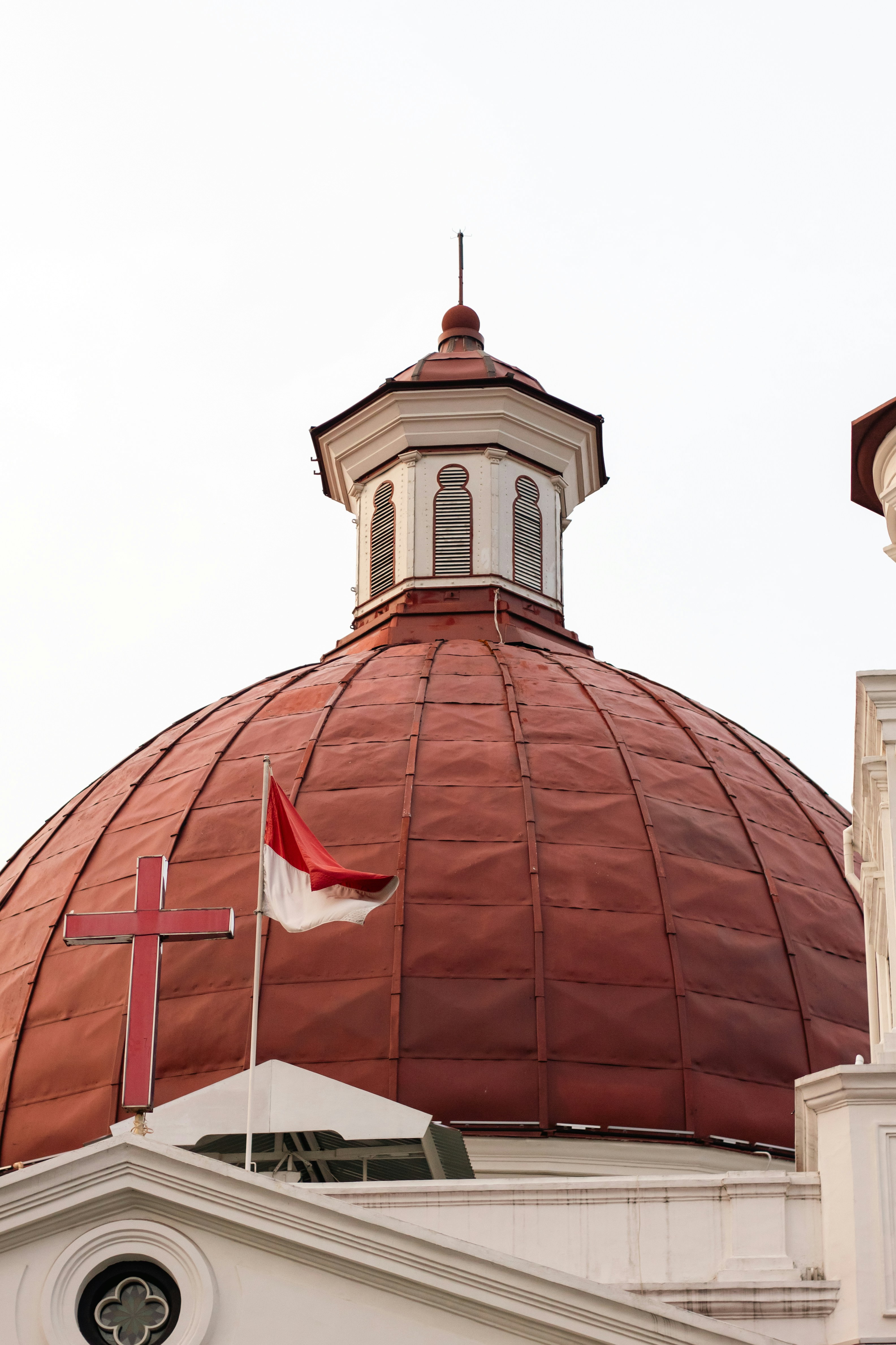 Church dome with cross and flag - Free Photo on Unsplash