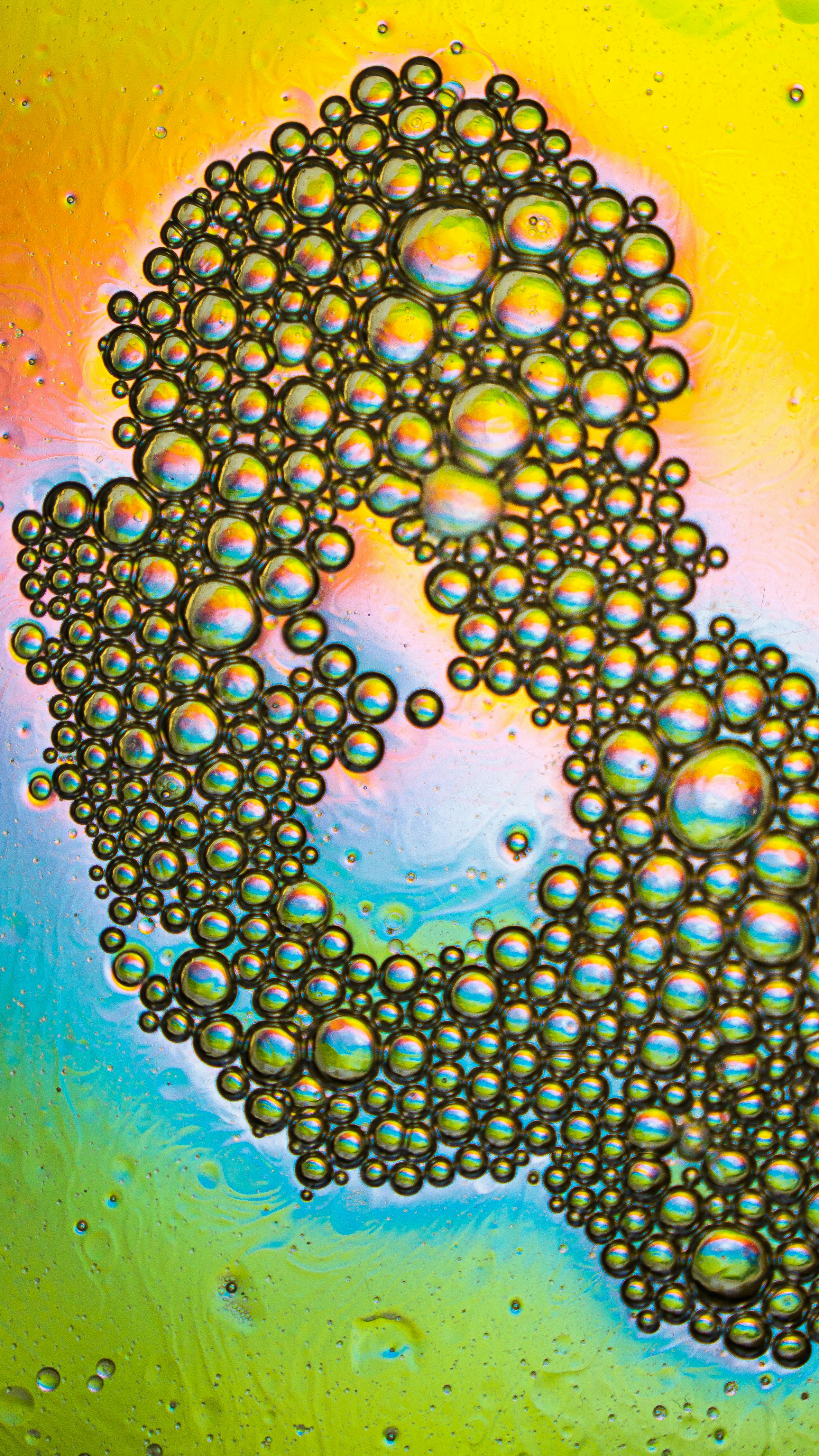 Iridescent oil bubbles on colorful background - Free Photo on Unsplash