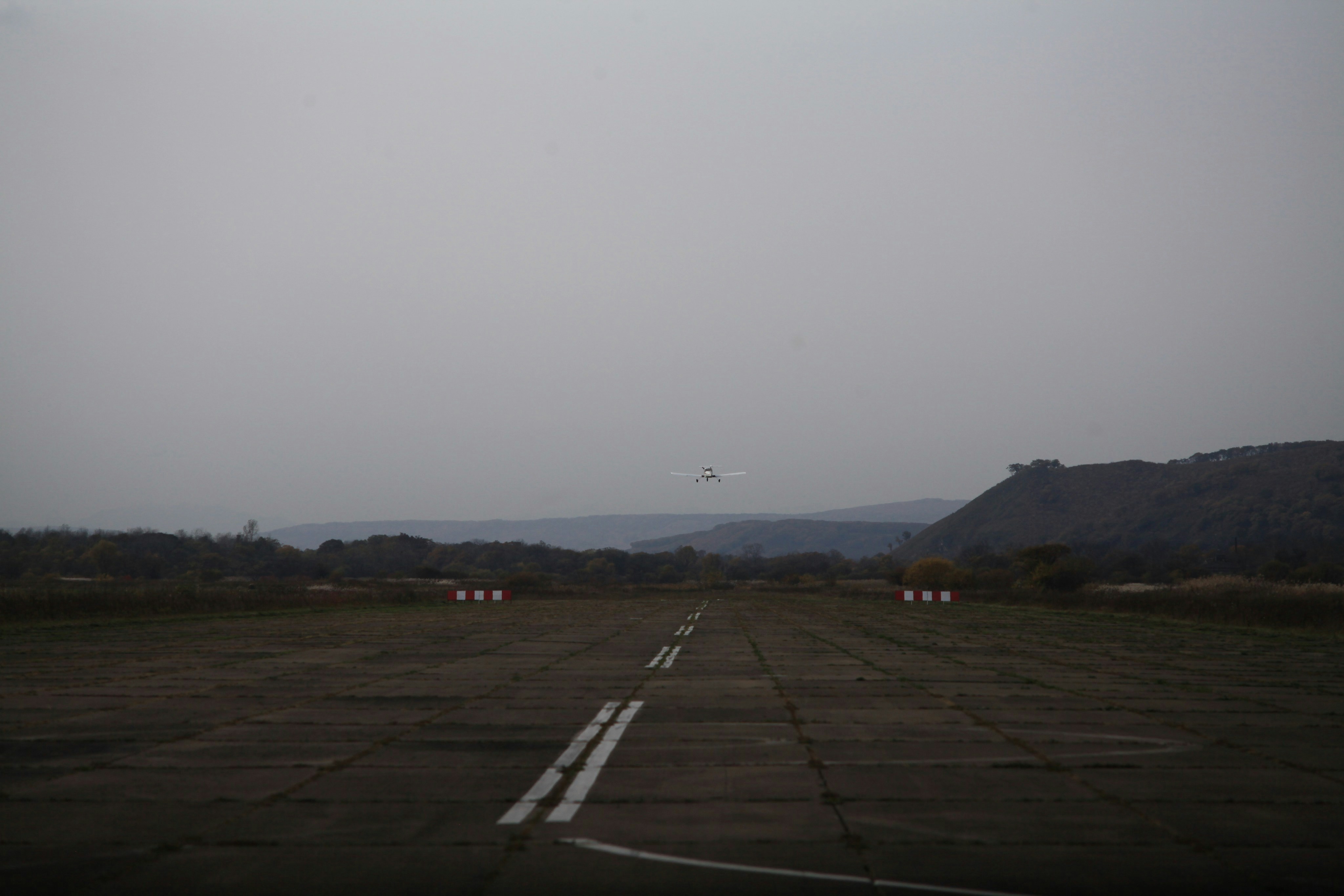 Light aircraft approaching concrete runway - Free Photo on Unsplash