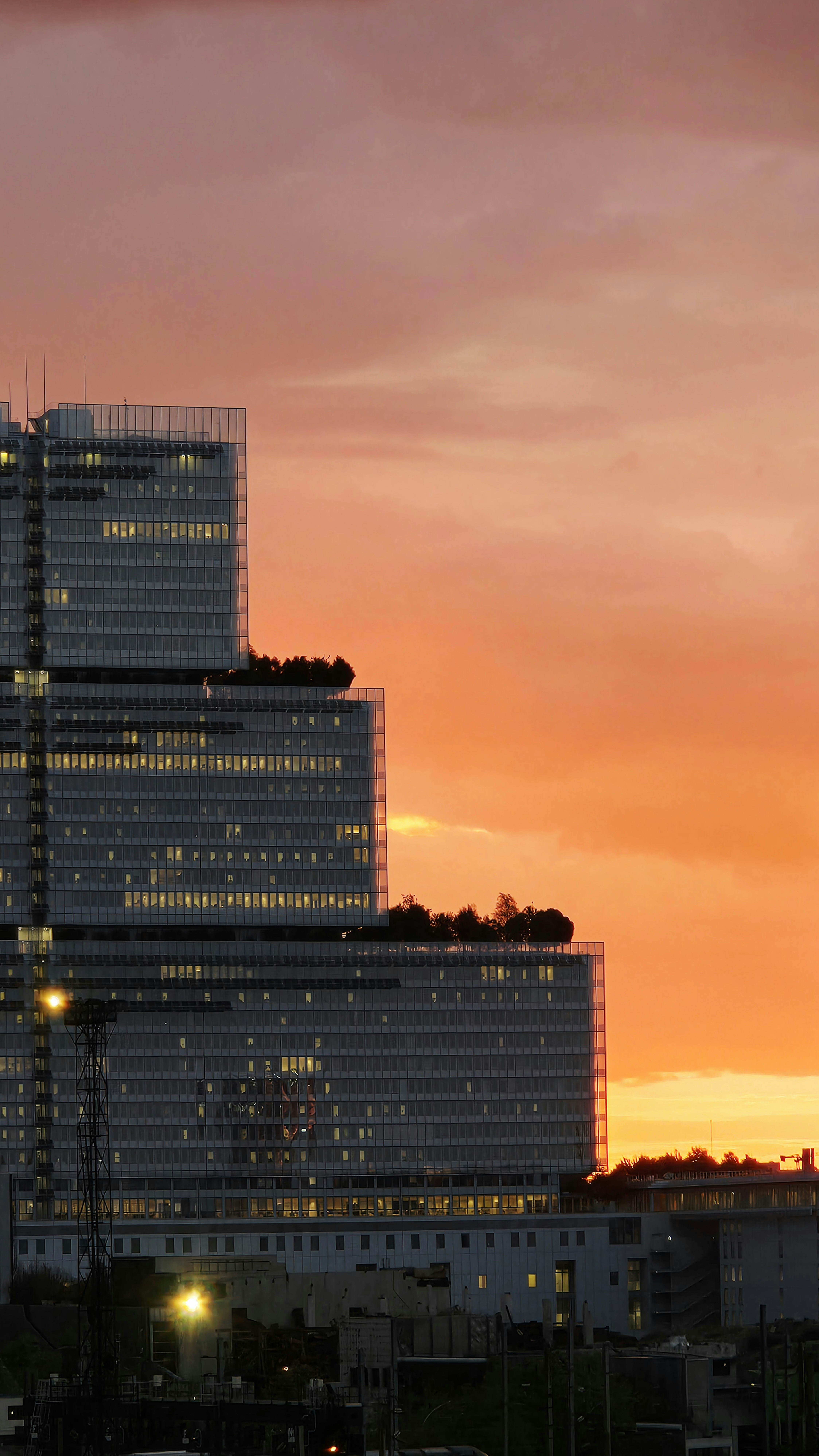 The Palais de Justice in Paris against a vibrant orange sky at golden hour