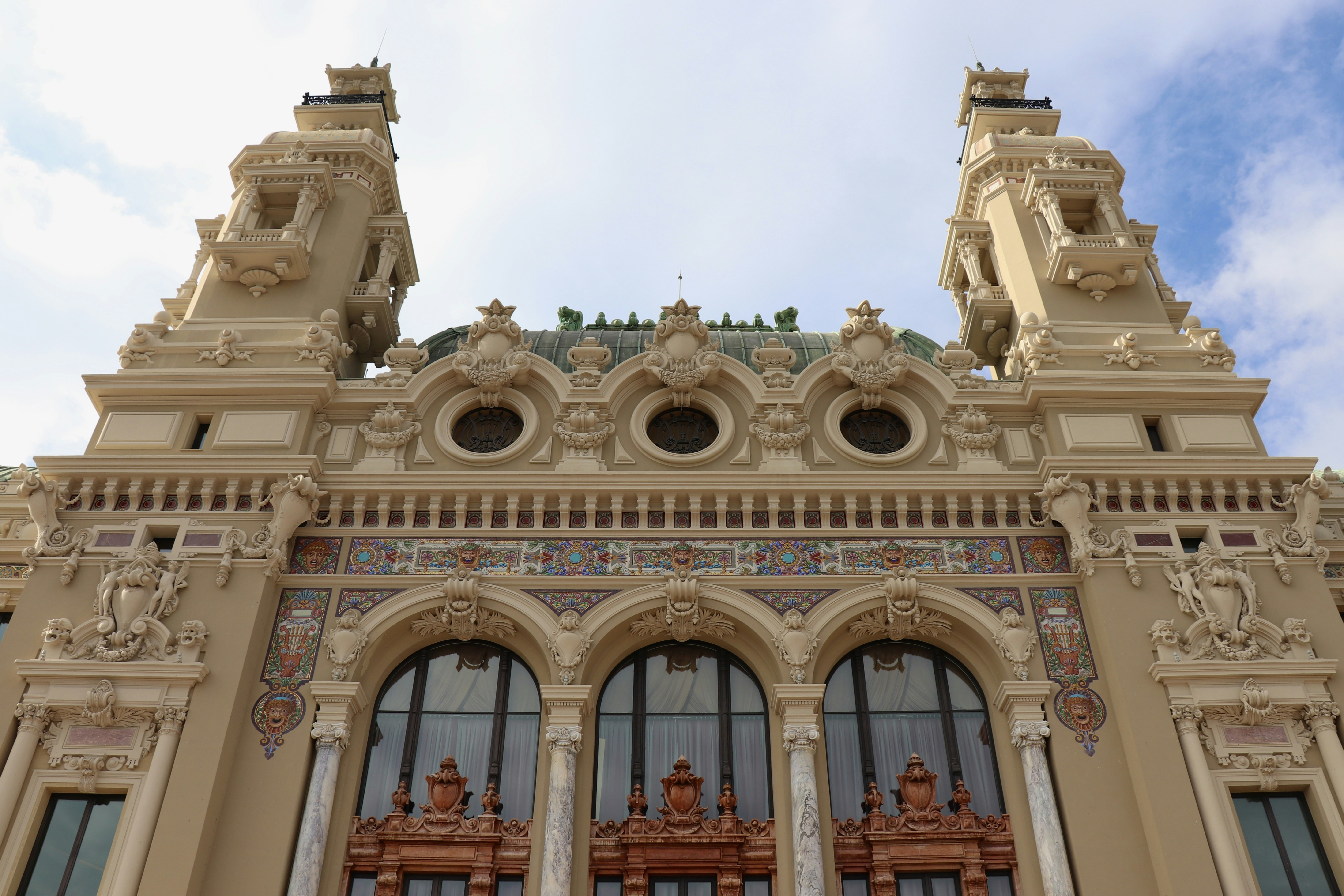The ornate facade of the Monte Carlo Casino in Monaco with twin towers and arched windows